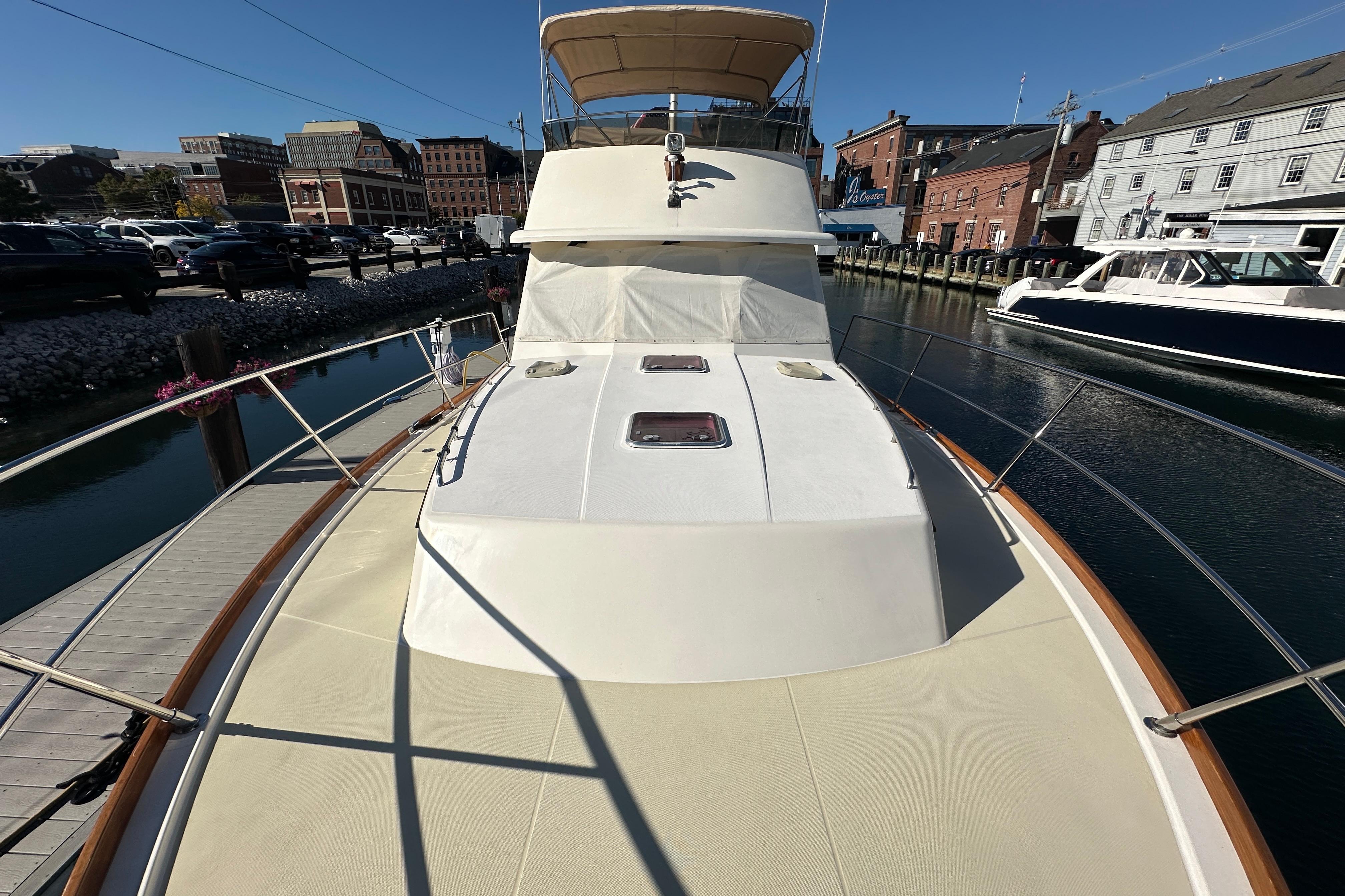 2006 Sabre 42 Fly Bridge yacht docked at a marina, showcasing its sleek design.