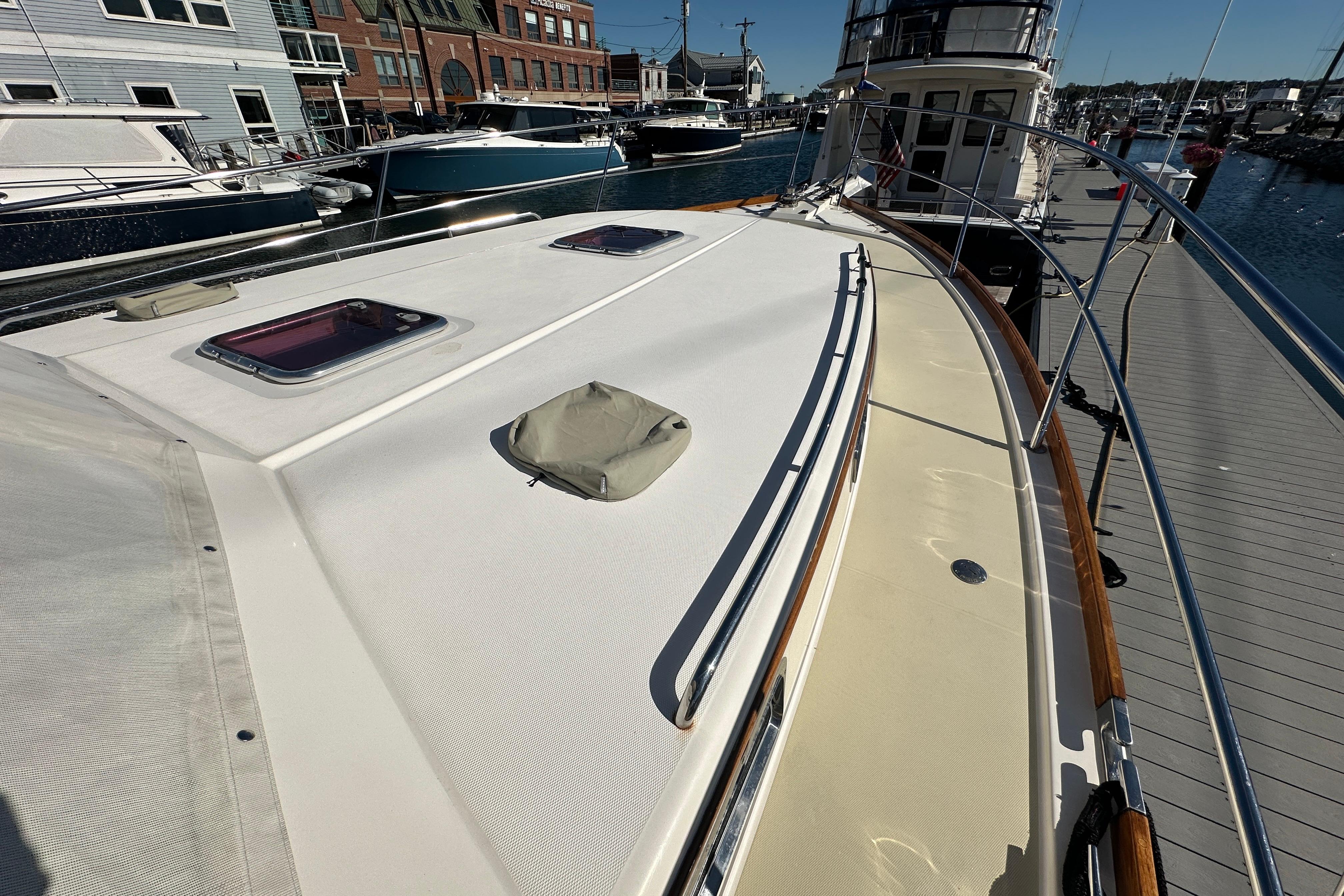 2006 Sabre 42 Fly Bridge yacht docked at marina, showcasing deck and hatch details.
