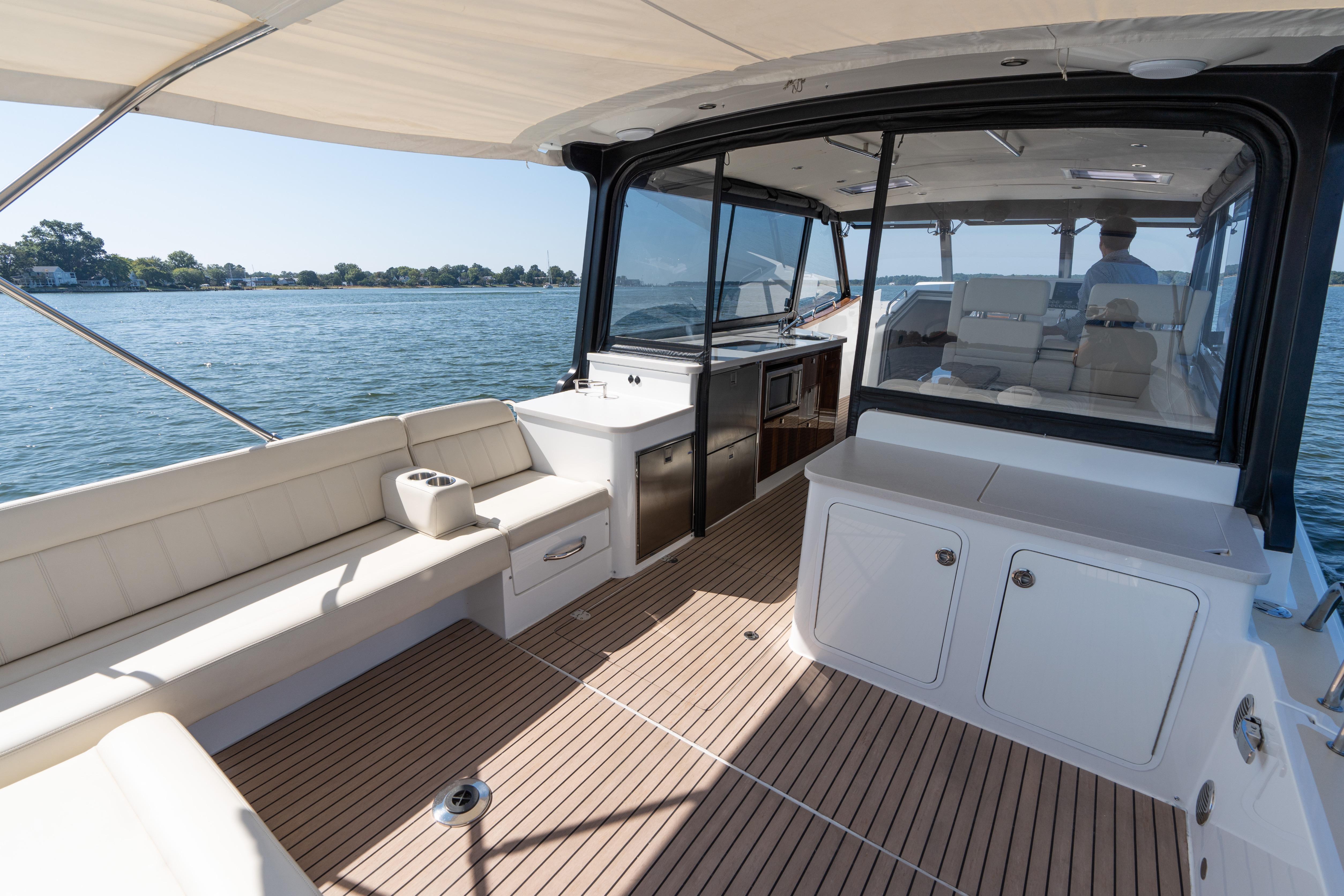 2023 MJM Yachts 4 model, featuring spacious deck and seating, cruising on calm waters.
