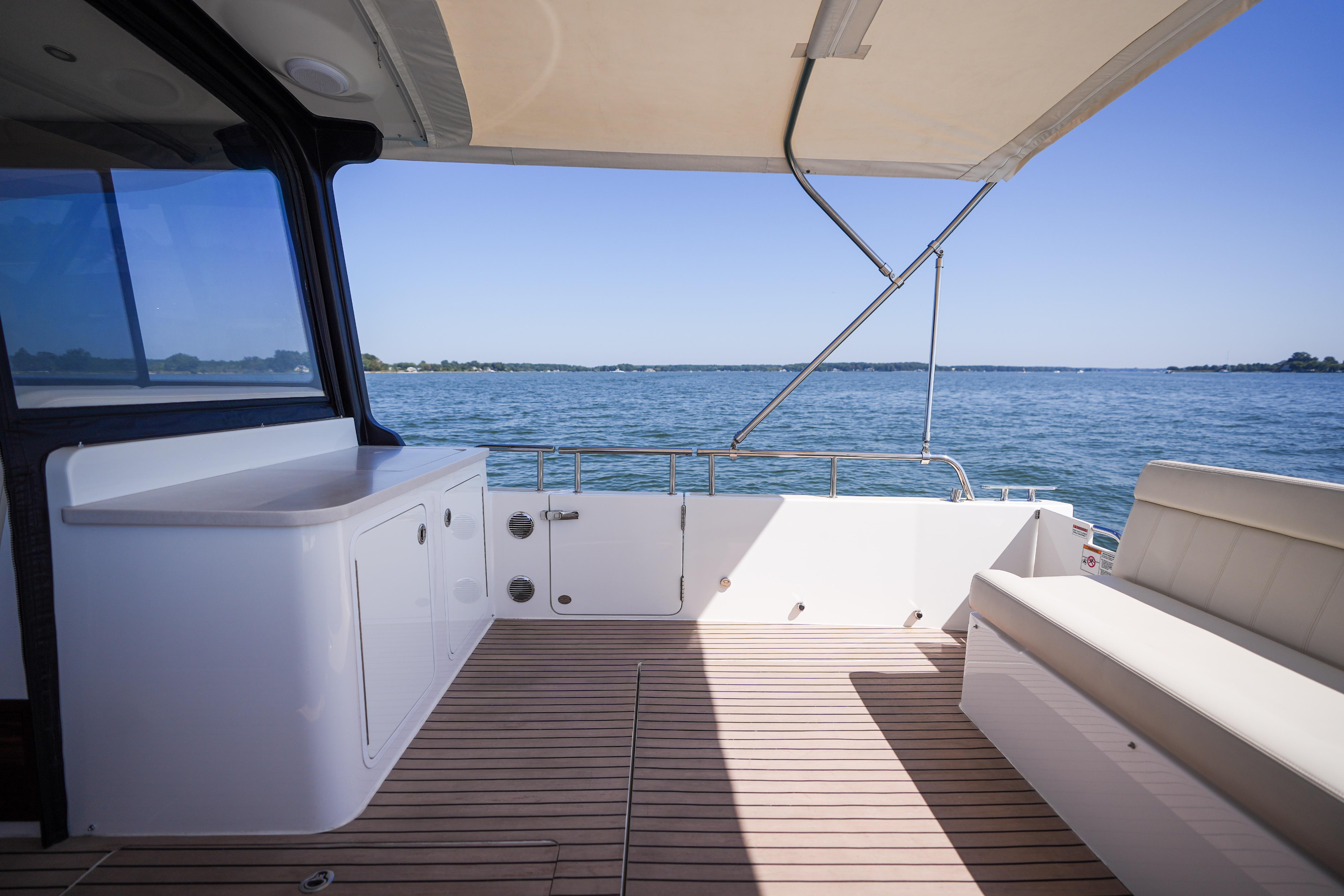 2023 MJM Yachts 4 model, featuring spacious deck with seating and ocean view.