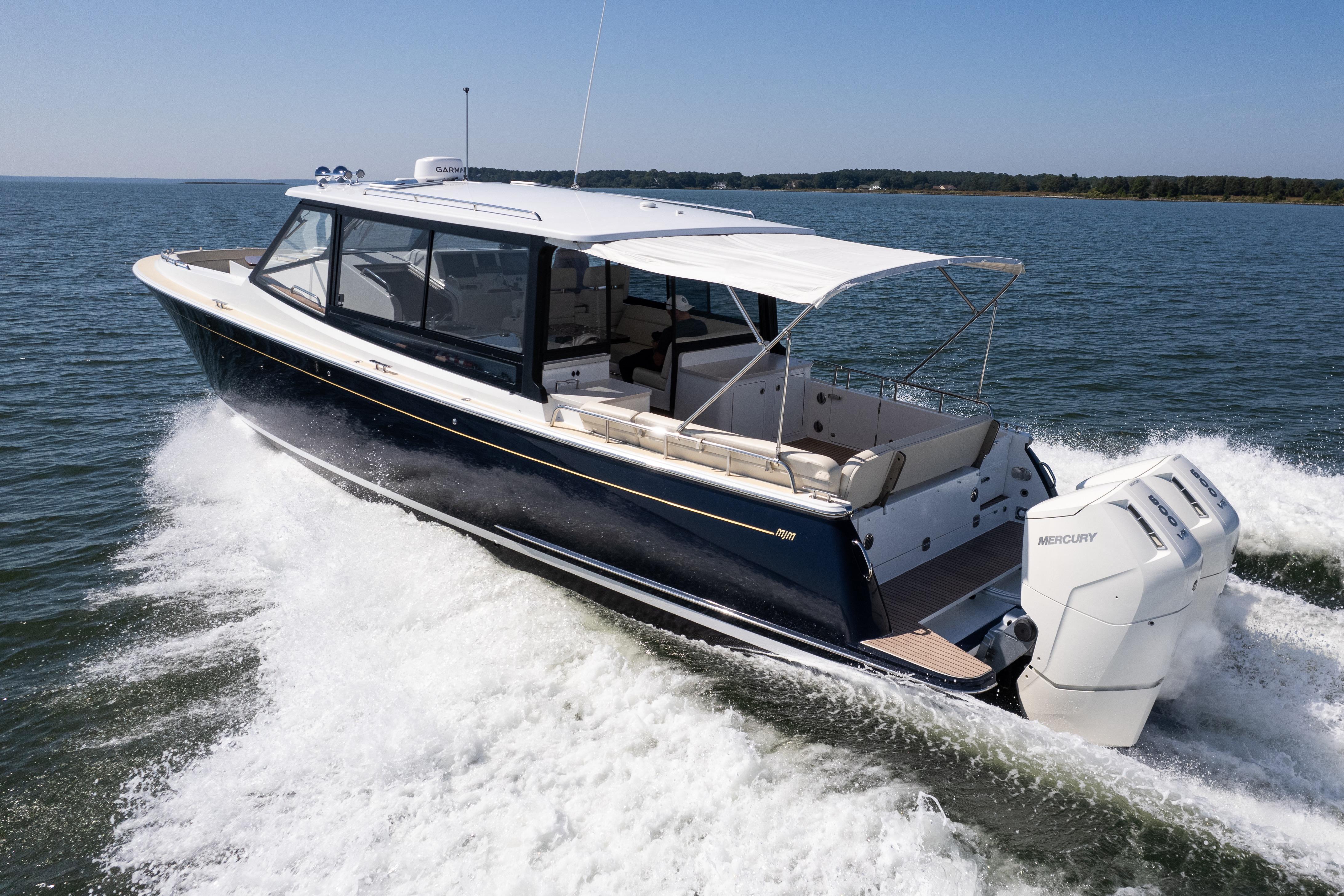 2023 MJM Yachts 4 cruising on open water with powerful Mercury engines.