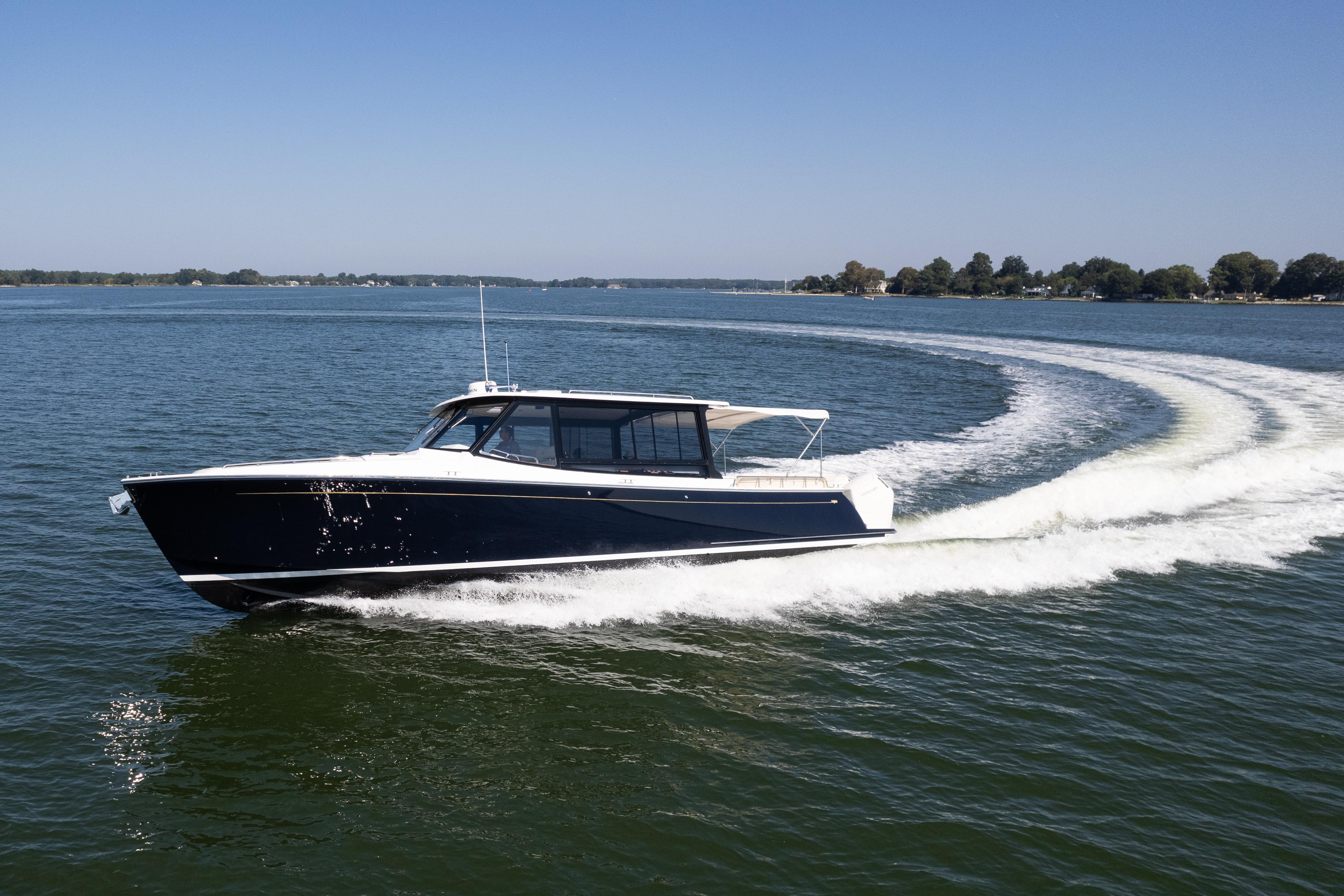 2023 MJM Yachts 4 cruising on open water, creating a dynamic wake.