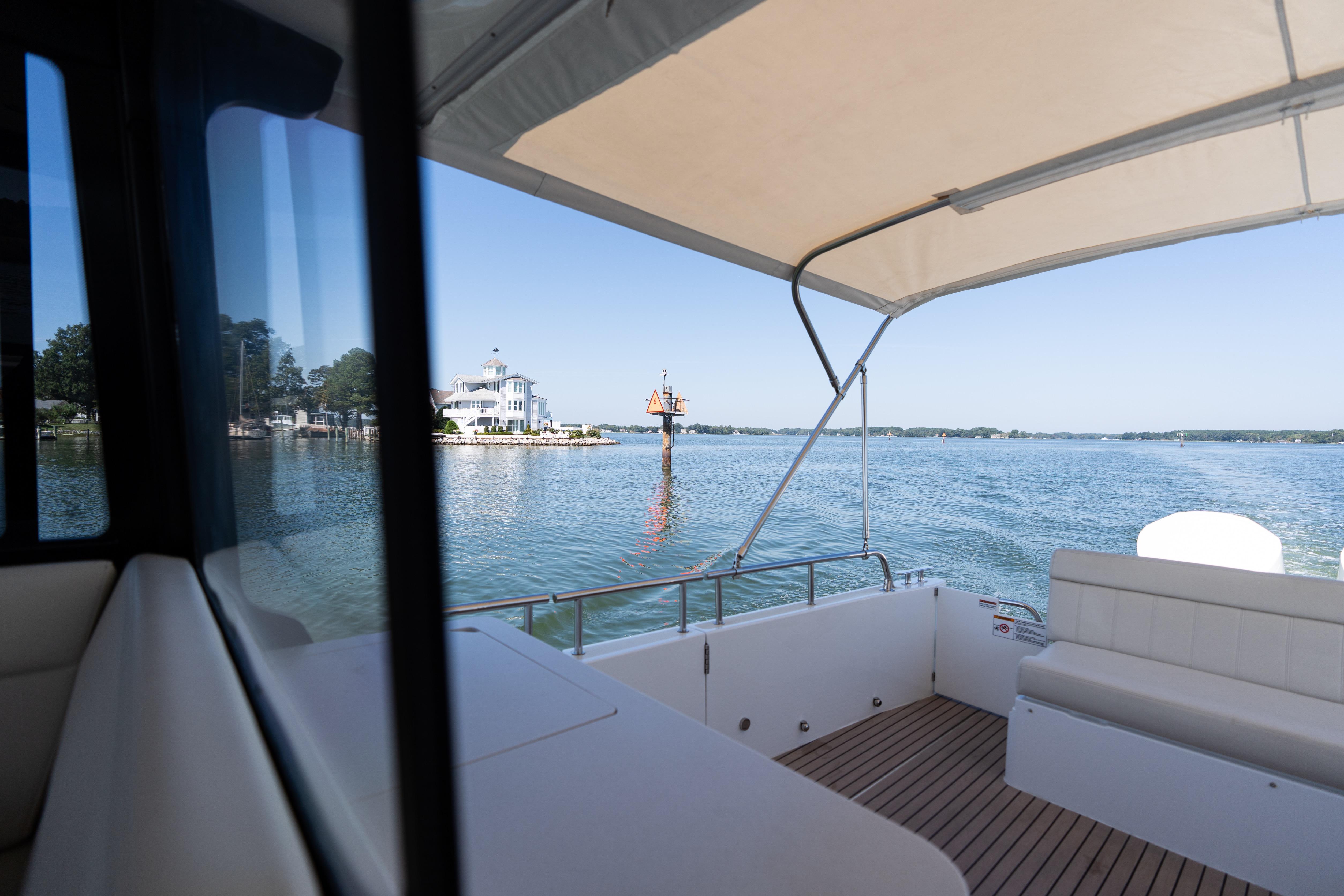 2023 MJM Yachts 4 interior view with scenic waterfront backdrop.