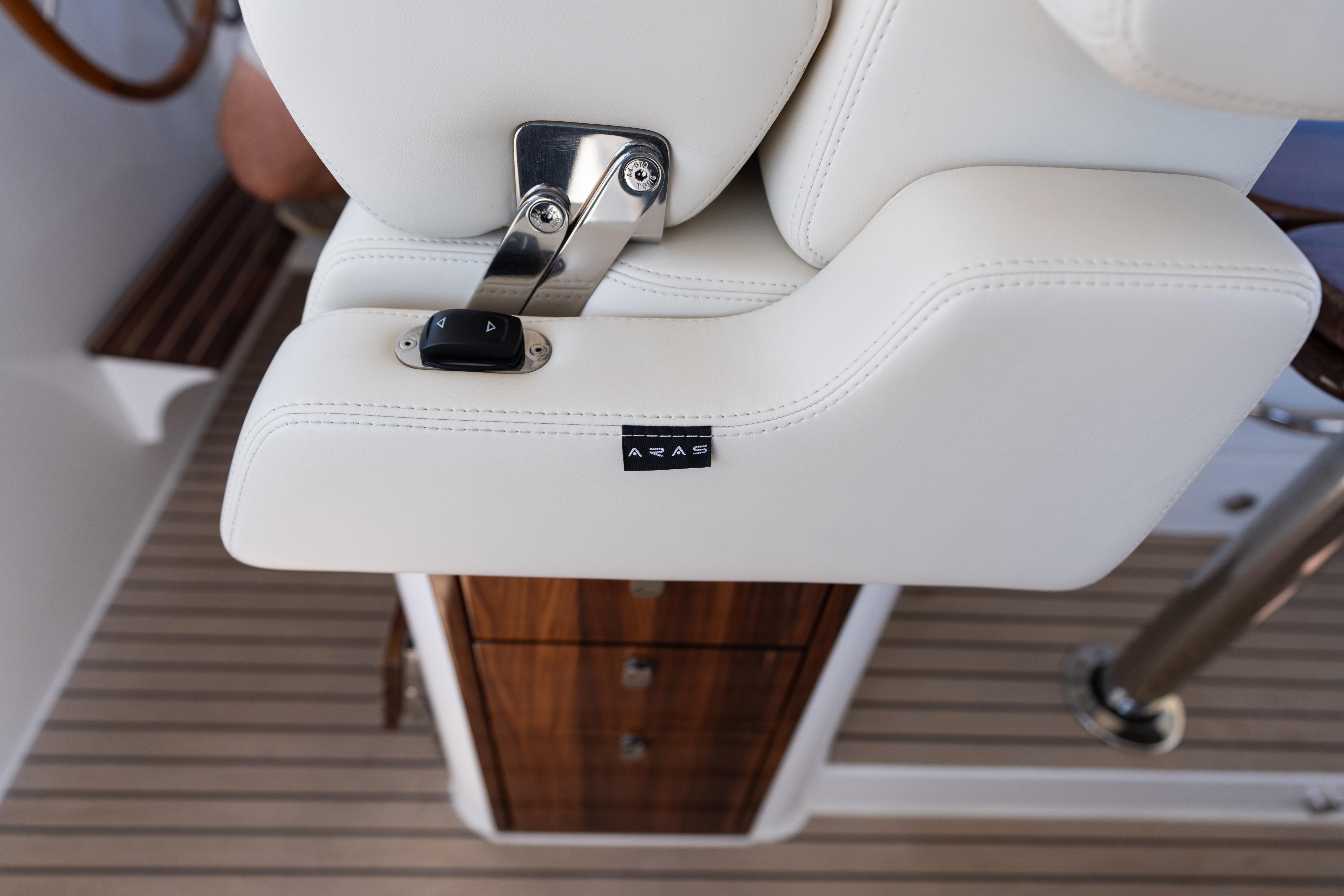 Luxury seating detail on 2023 MJM Yachts 4, featuring white upholstery and control buttons.