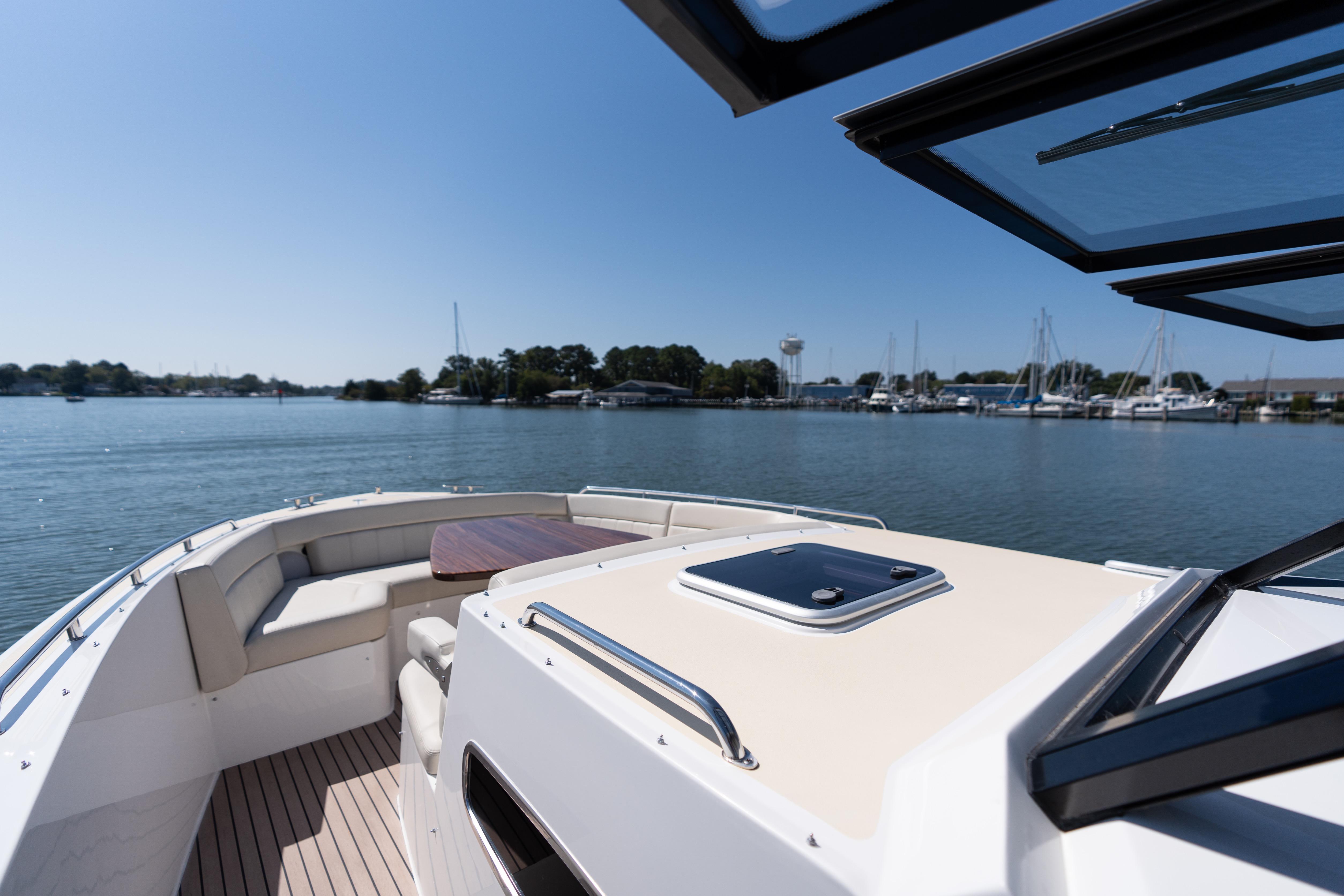 2023 MJM Yachts 4 on calm water, featuring spacious deck and seating area.