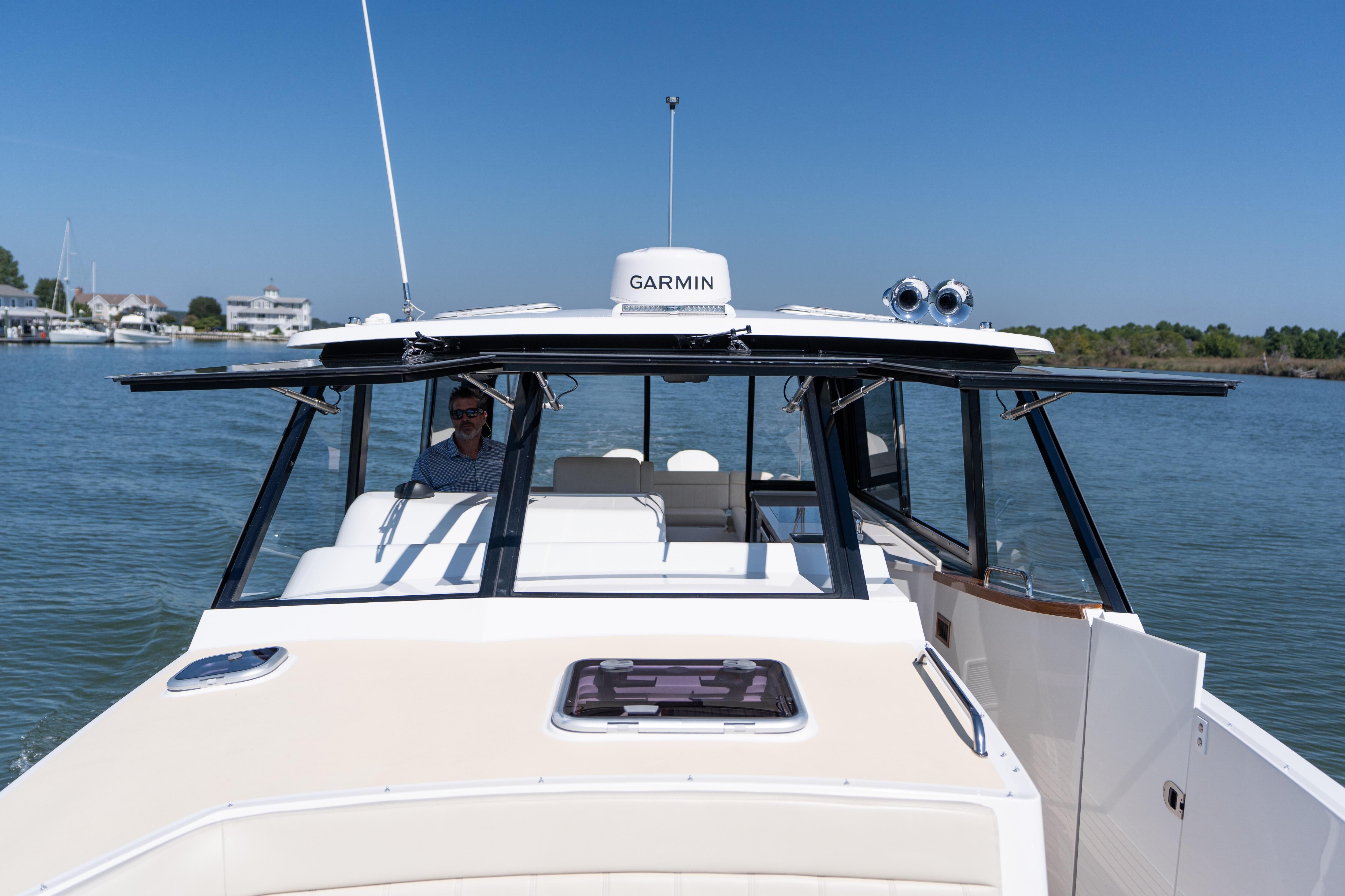 2023 MJM Yachts 4 cruising on calm waters under clear blue skies.