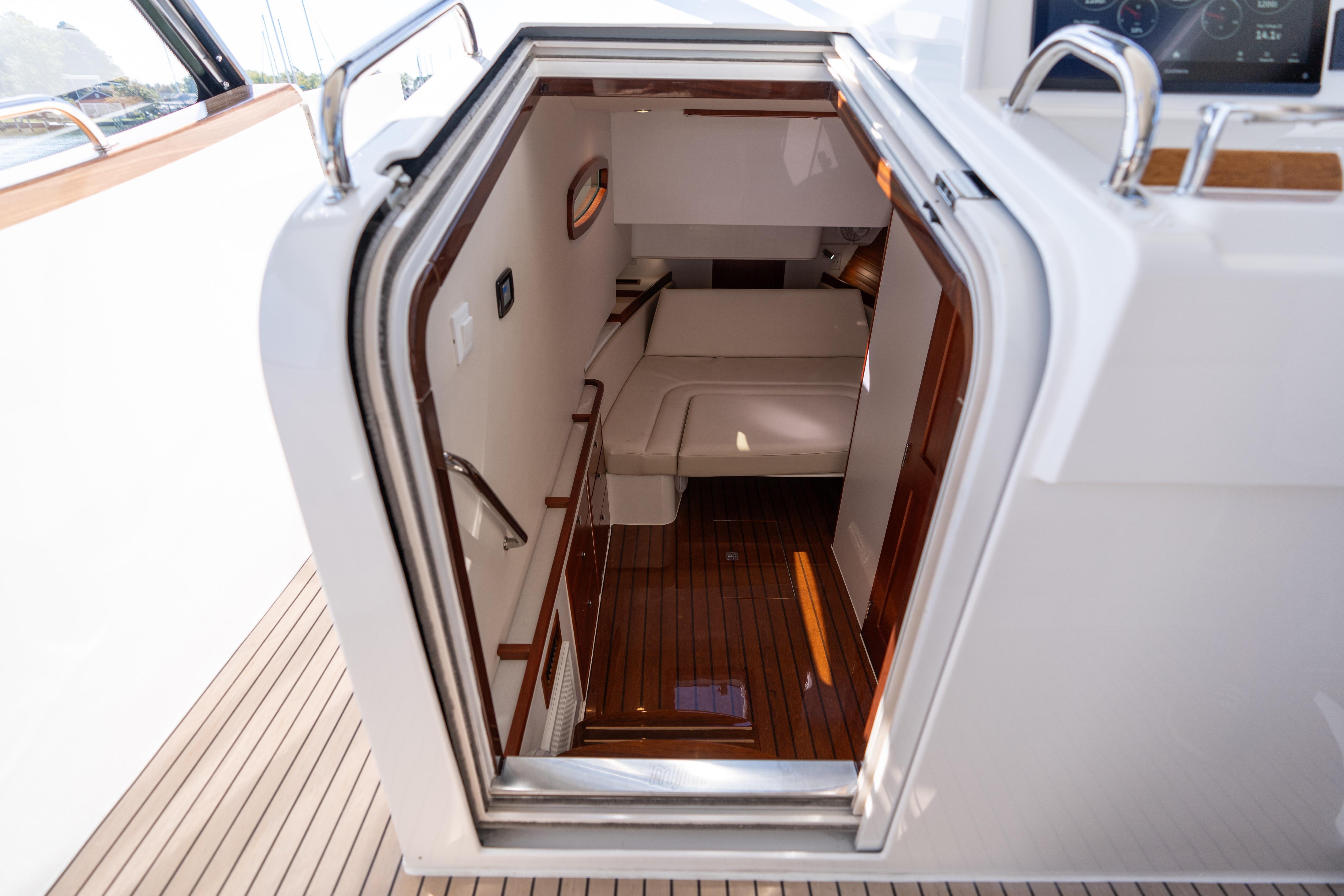 Interior view of 2023 MJM Yachts 4, showcasing elegant cabin entrance and wooden flooring.