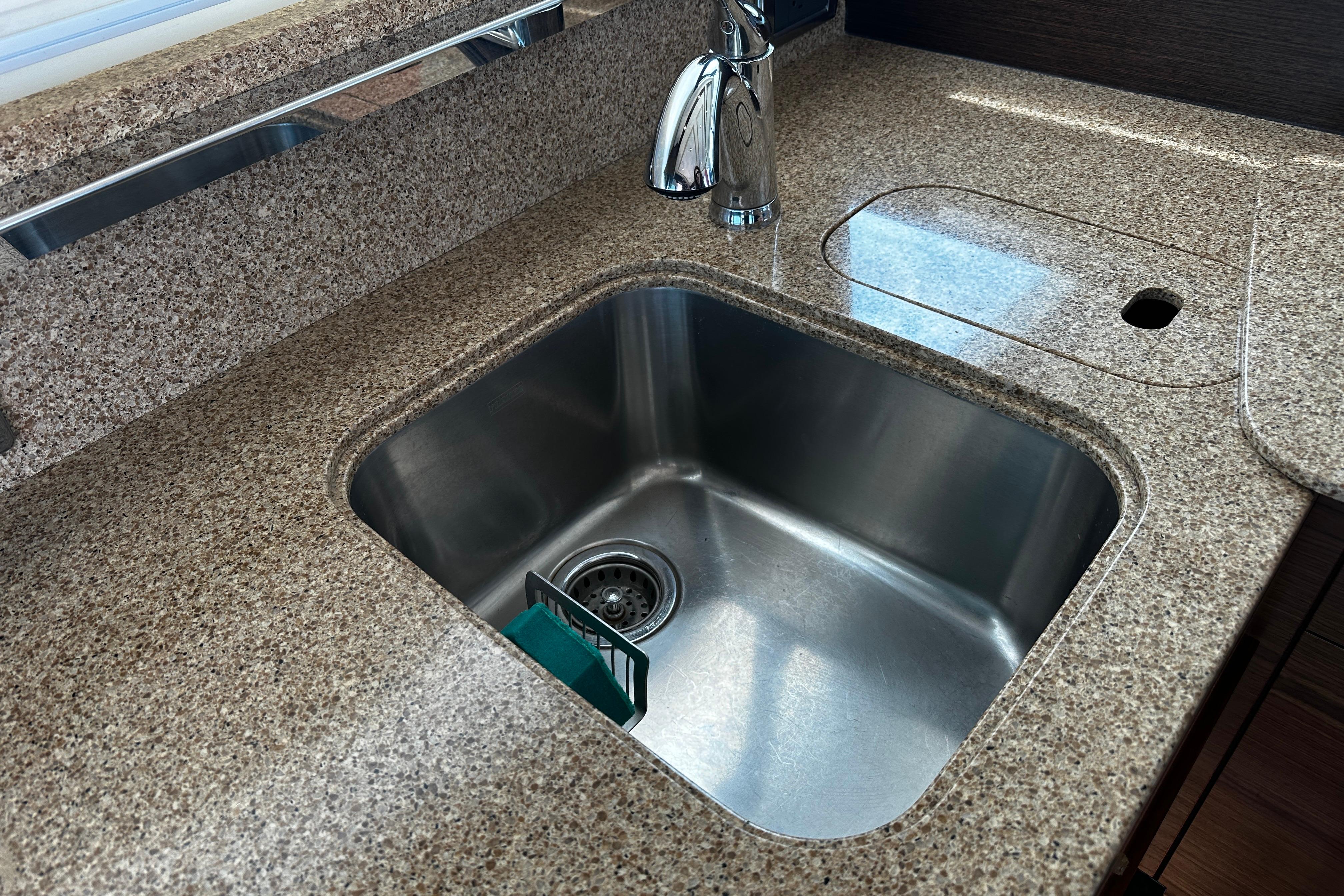 Granite countertop with stainless steel sink in 2014 Tiara 5000 Coupe.