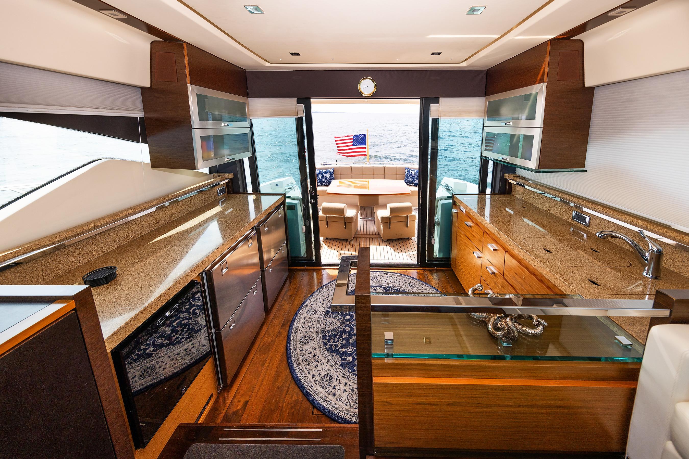 Luxurious interior of 2014 Tiara 5000 Coupe yacht with elegant wood finishes and ocean view.
