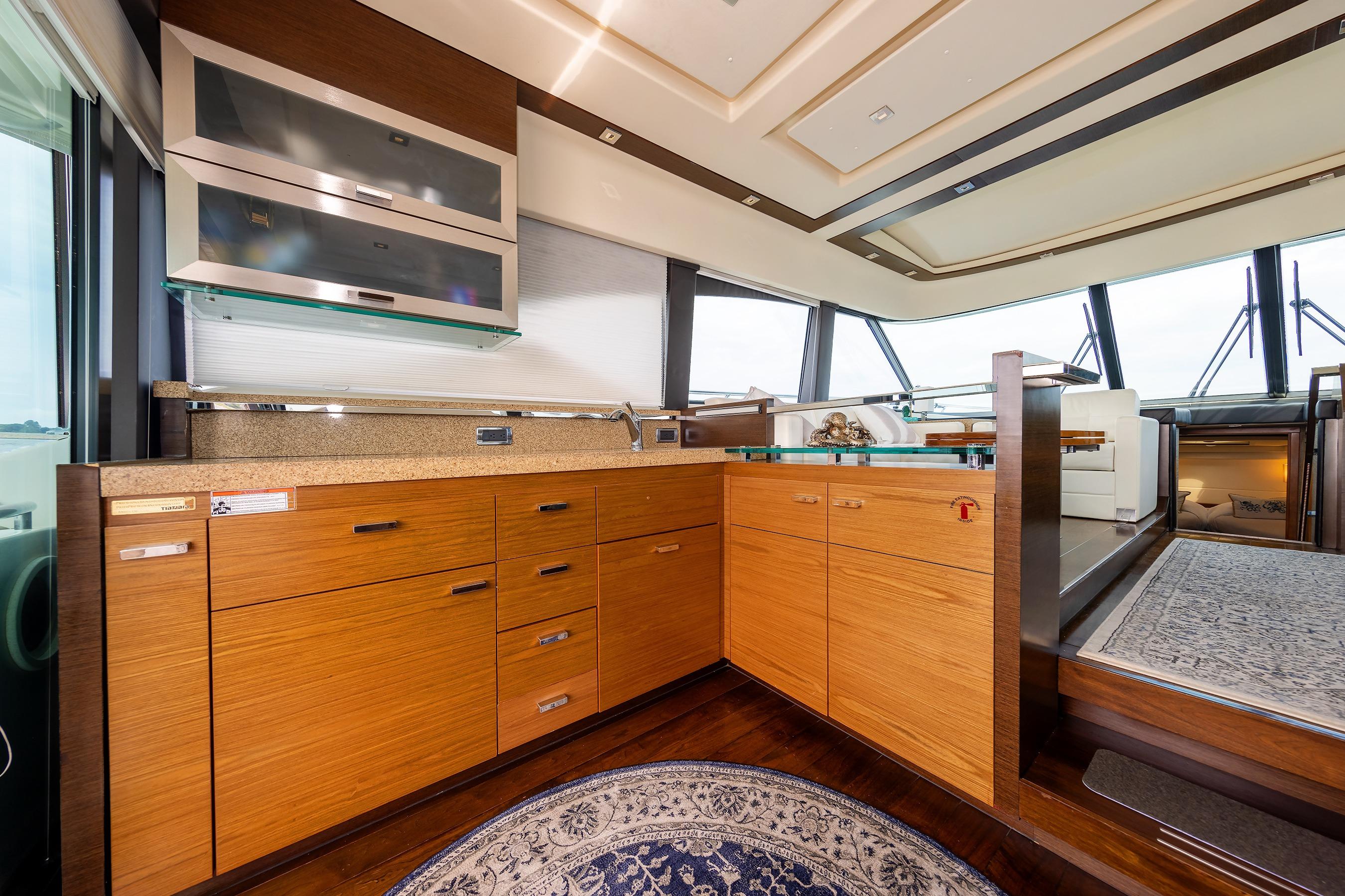 Luxurious interior of 2014 Tiara 5000 Coupe yacht with modern kitchen design.
