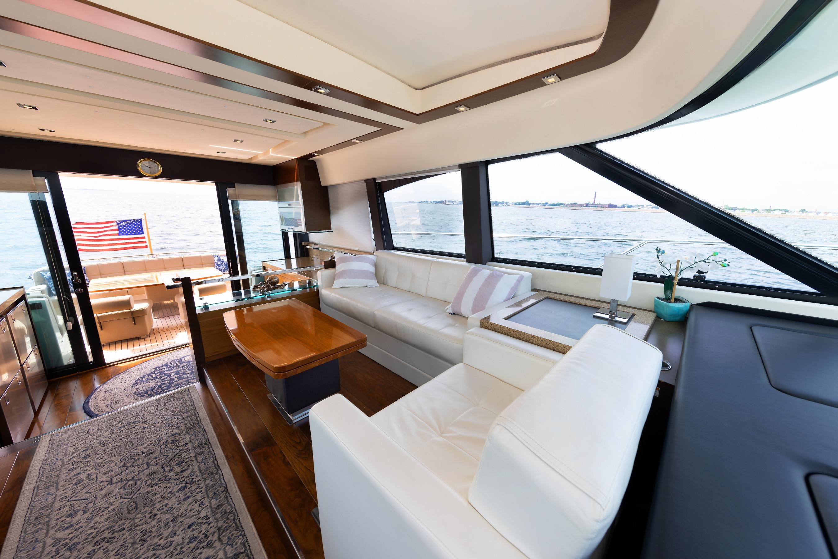Luxurious interior of 2014 Tiara 5000 Coupe yacht with ocean view and American flag.
