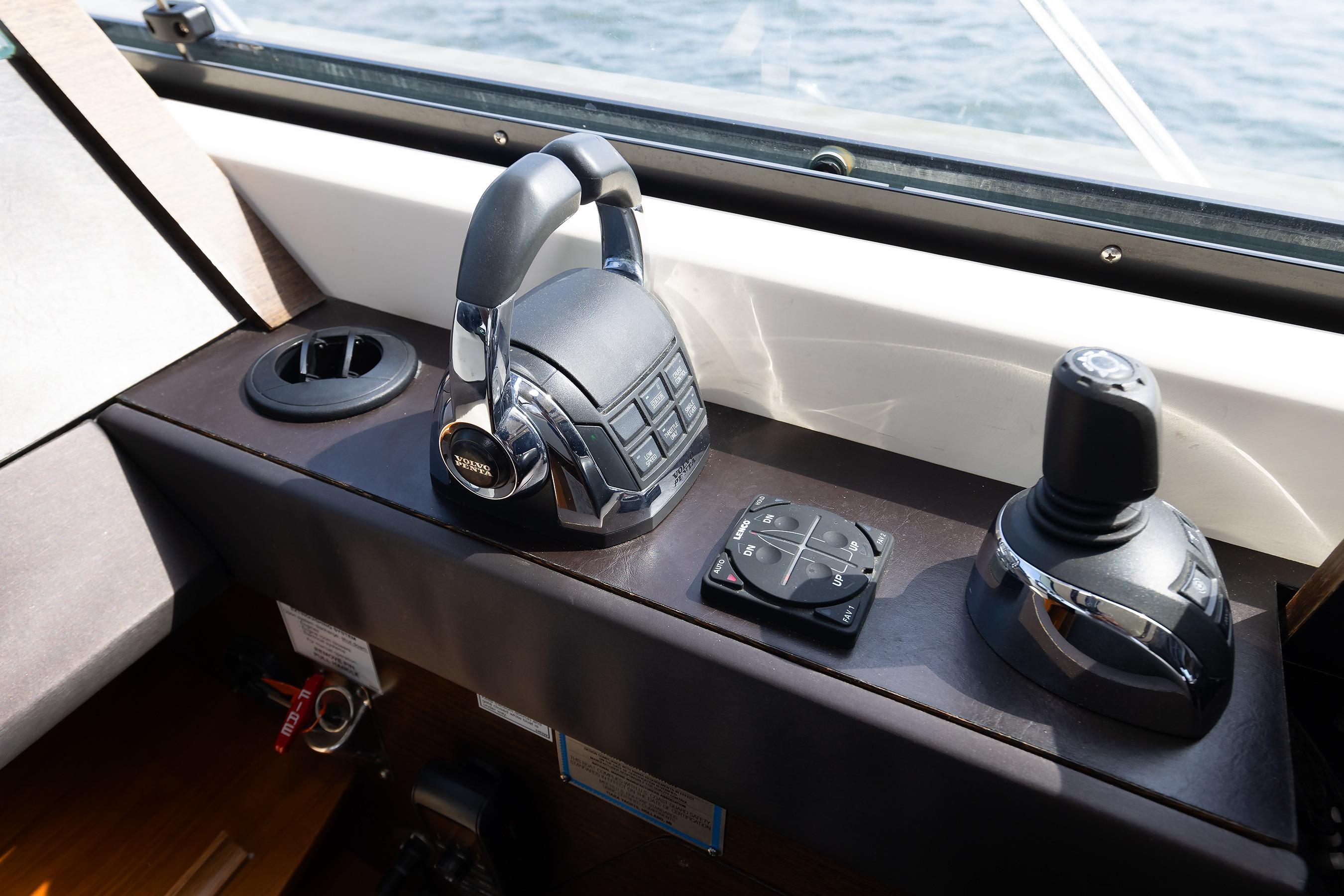 Control panel of a 2014 Tiara 5000 Coupe boat with joystick and throttle.