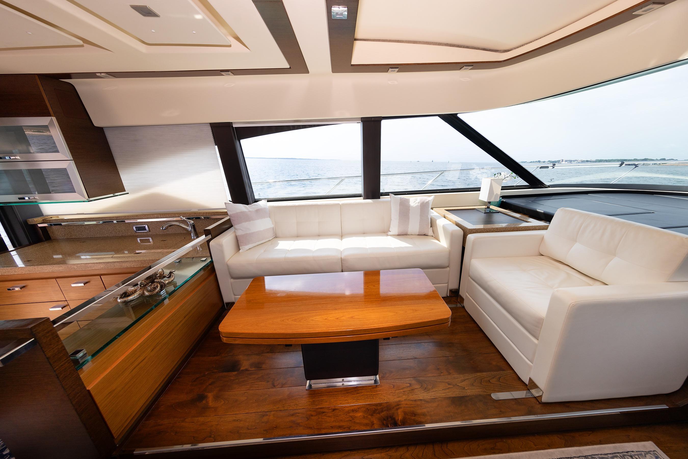 Luxurious interior of 2014 Tiara 5000 Coupe yacht with elegant seating and panoramic windows.