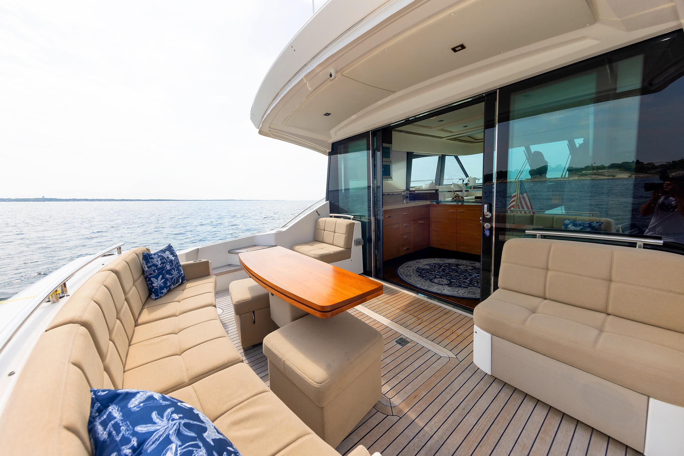 Luxurious 2014 Tiara 5000 Coupe yacht with elegant outdoor seating and ocean view.