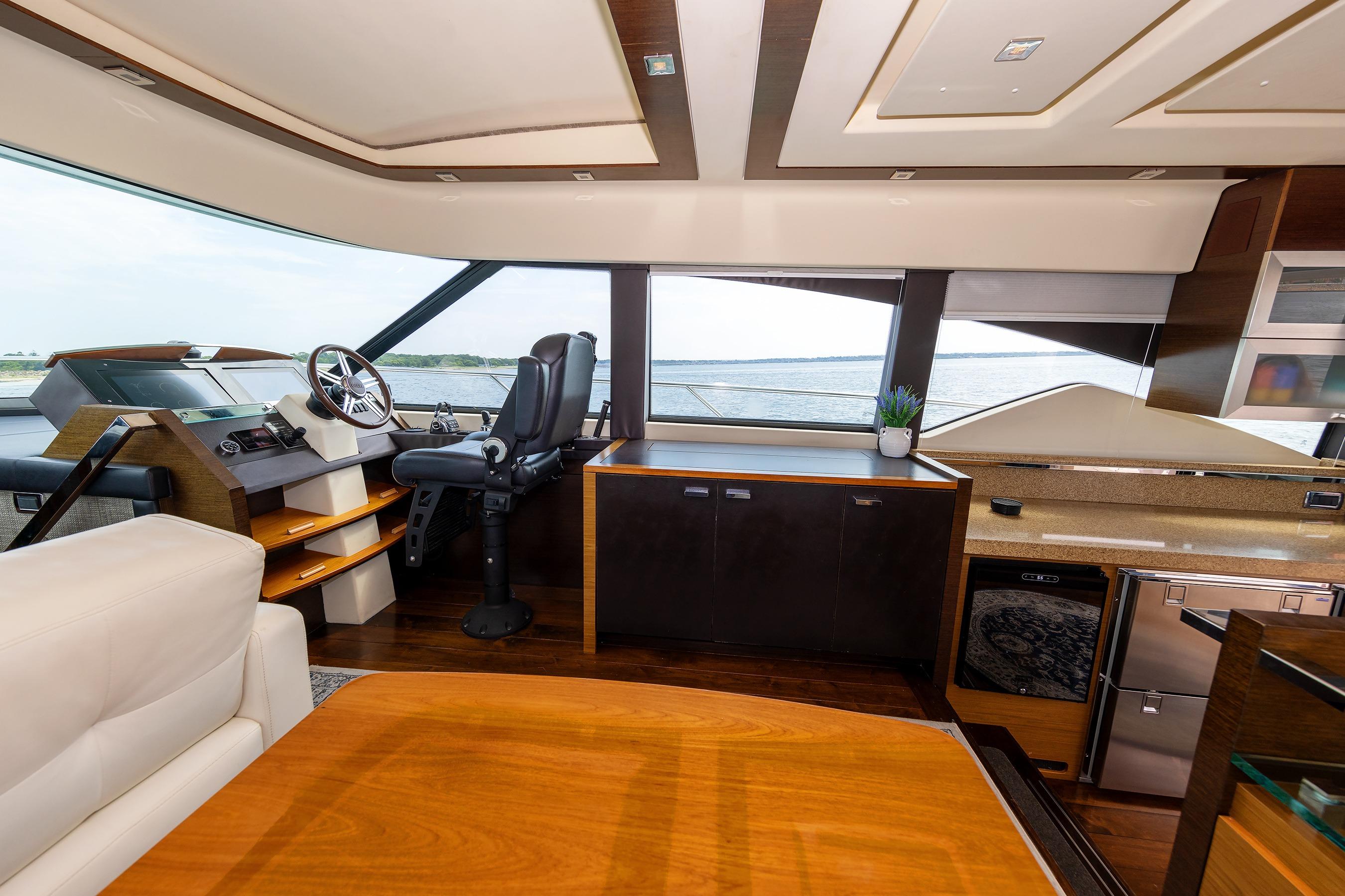 Luxurious interior of 2014 Tiara Yachts 5000 Express with helm, seating, and modern amenities.