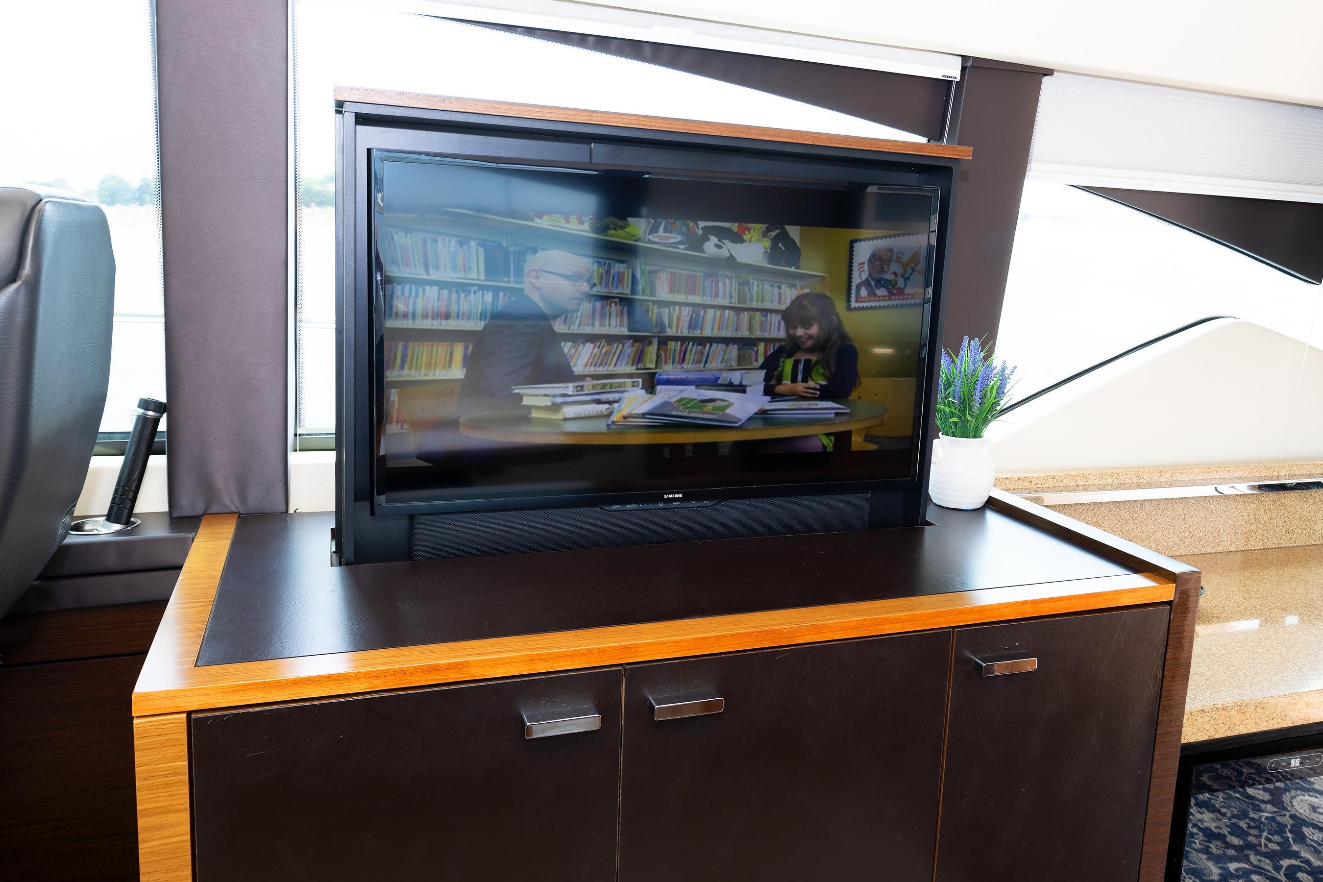 Interior of 2014 Tiara 5000 Coupe with TV and potted plant on cabinet.