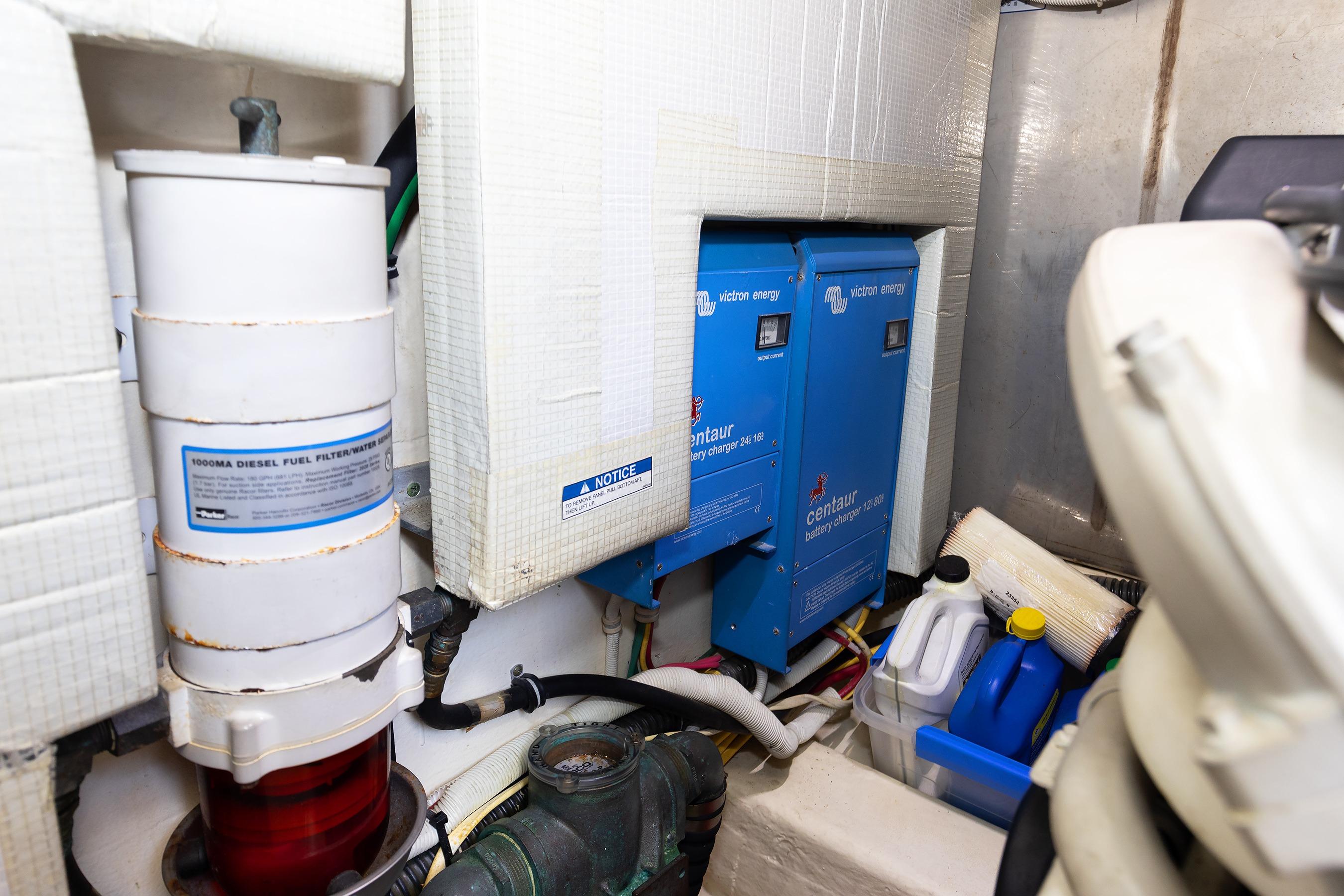 Engine room of 2014 Tiara 5000 Coupe with battery chargers and diesel filter.