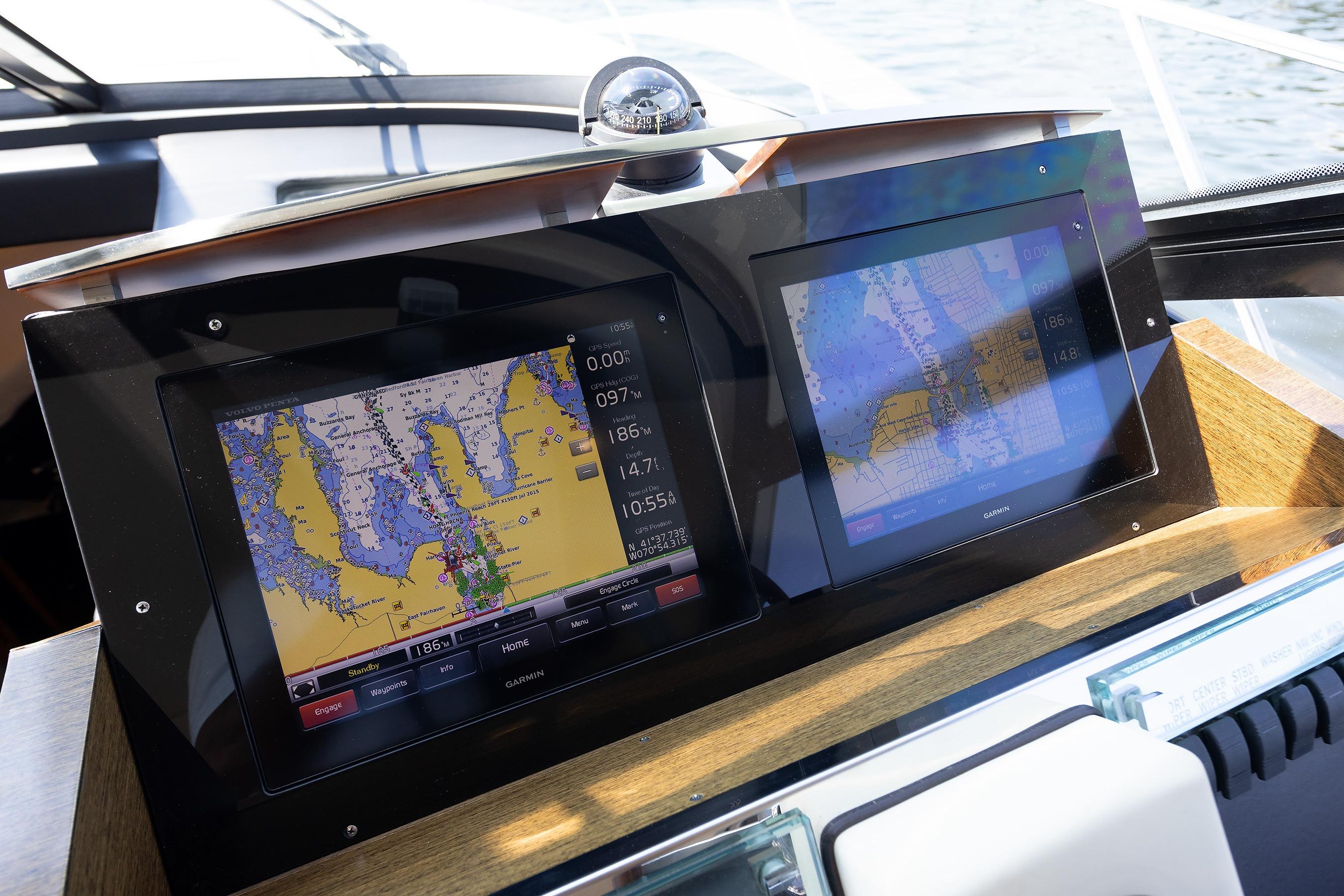 Navigation screens on a 2014 Tiara 5000 Coupe boat, displaying detailed marine maps.