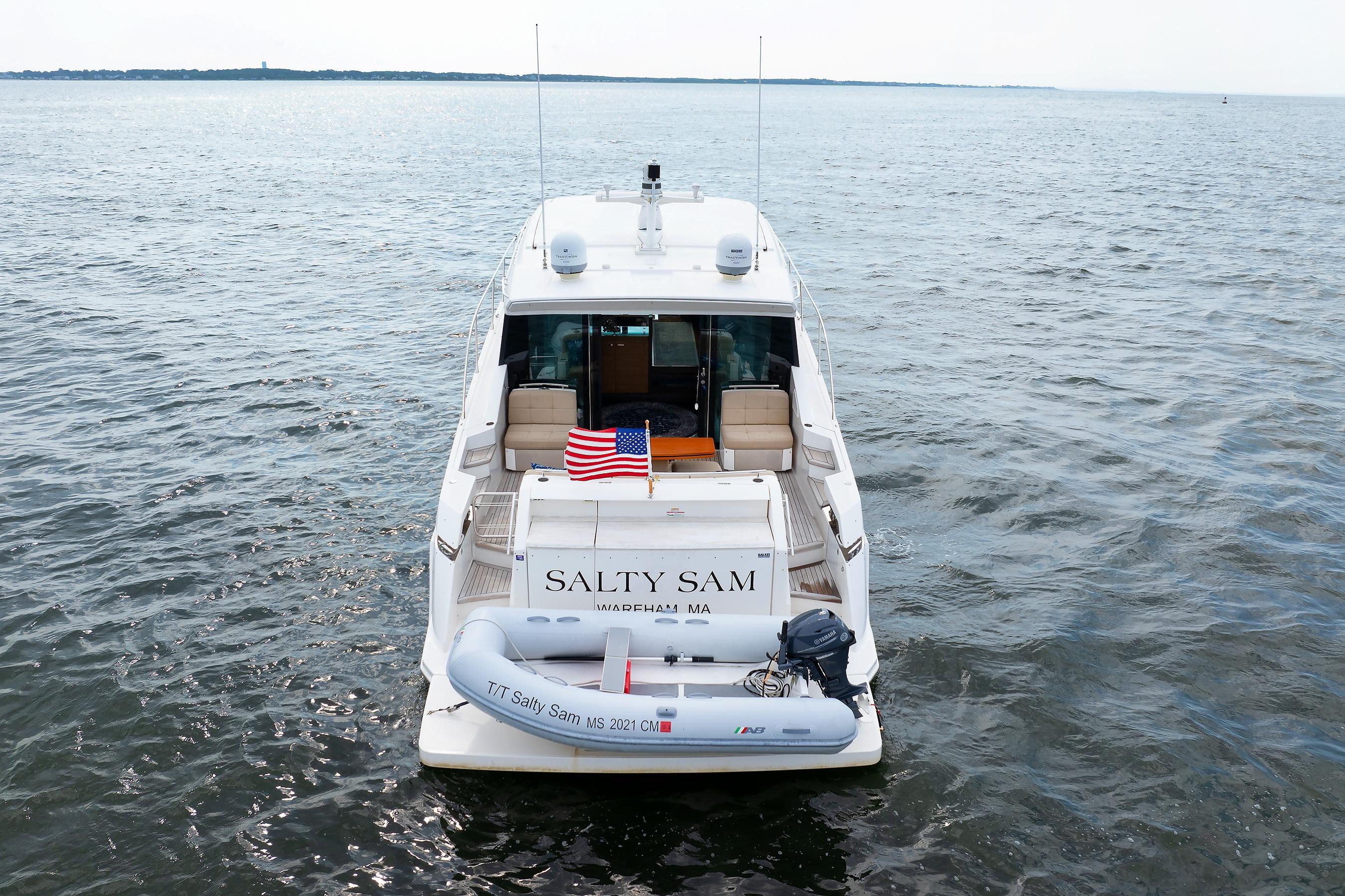 2014 Tiara 5000 Coupe yacht u0022Salty Samu0022 on open water, rear view with American flag.