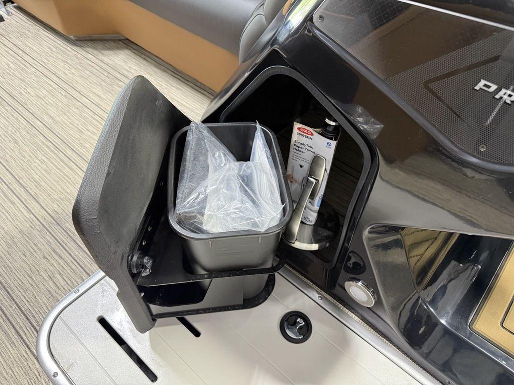 2025 Premier 230 Solaris RL boat interior with built-in trash bin and storage compartment.
