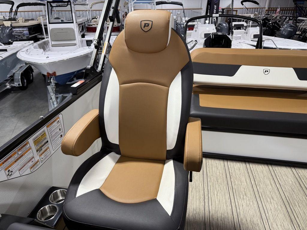 2025 Premier 230 Solaris RL boat seat with tan and white upholstery in showroom.