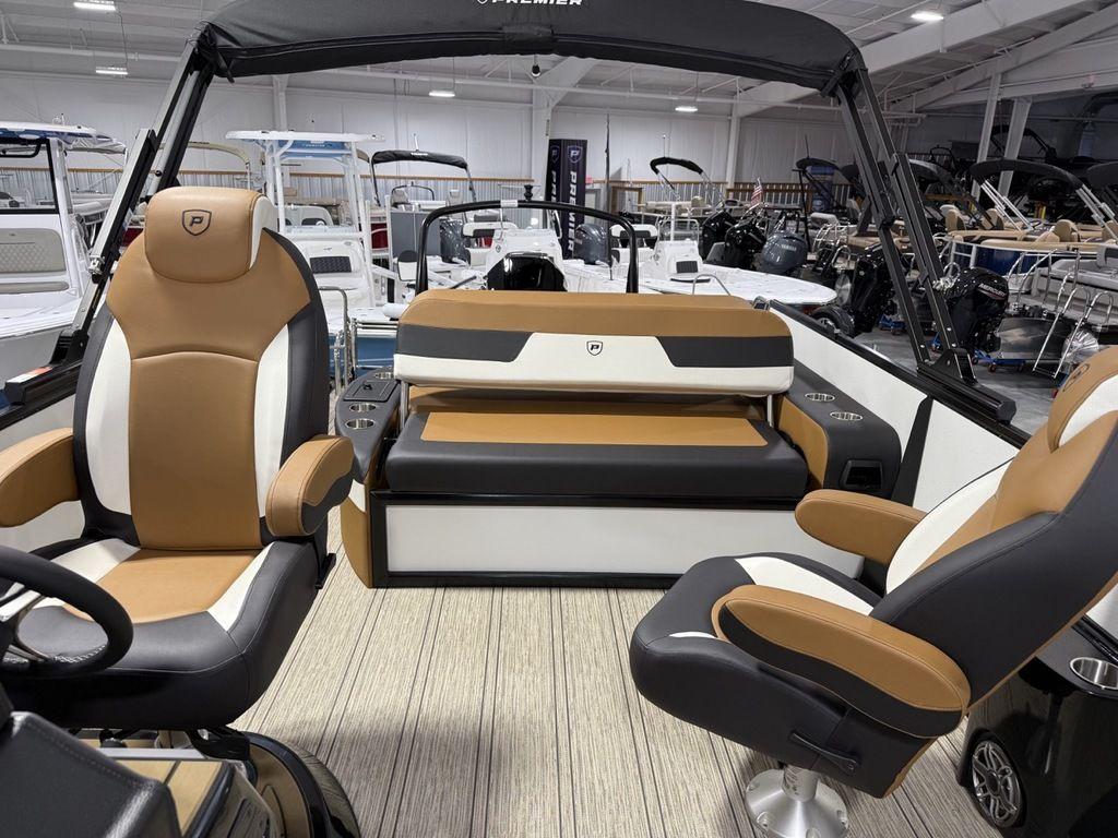 2025 Premier 230 Solaris RL boat interior with tan and black seating in showroom.