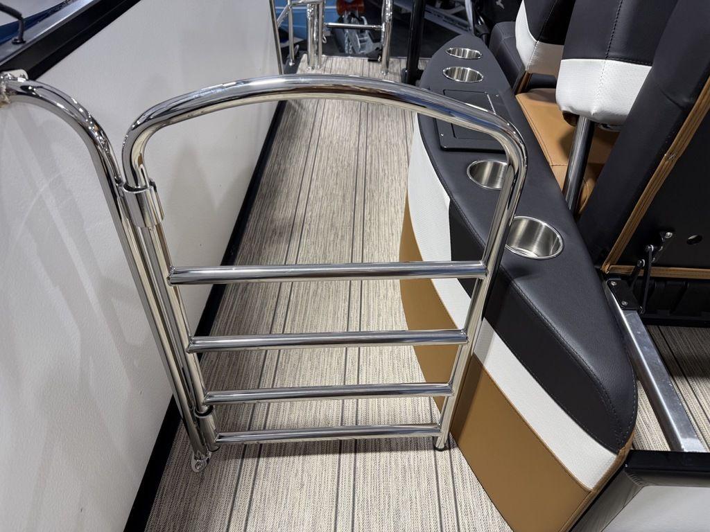 2025 Premier 230 Solaris RL boat interior with stainless steel gate and cup holders.