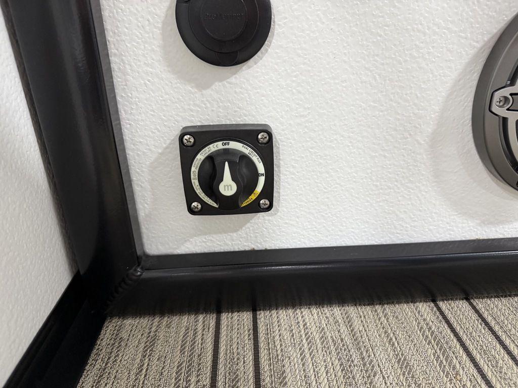 Control panel on 2025 Premier 230 Solaris RL boat, featuring a switch and outlet.