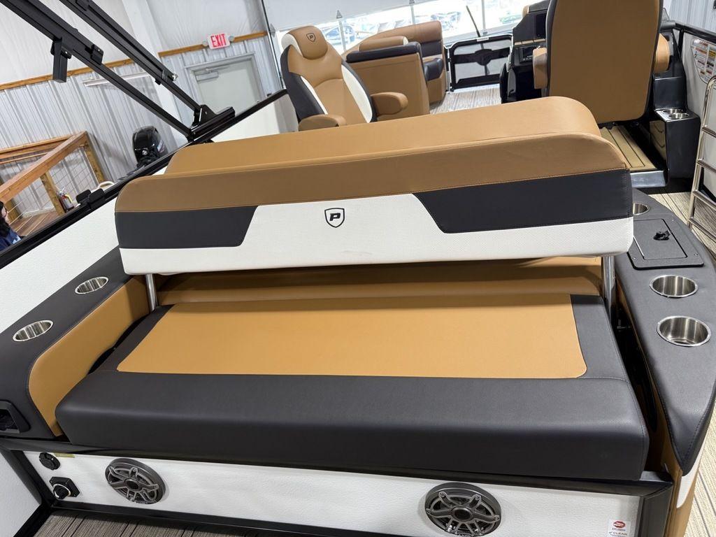 2025 Premier 230 Solaris RL boat interior with tan and black seating, cup holders, and speakers.