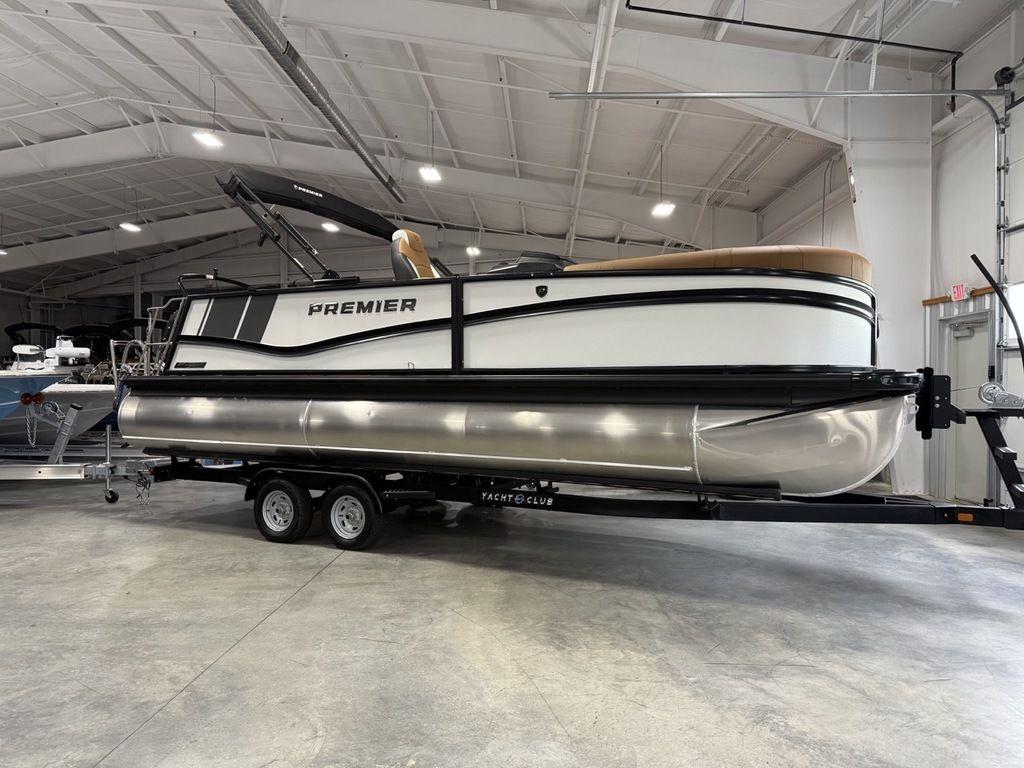 2025 Premier 230 Solaris RL pontoon boat on trailer in indoor showroom.