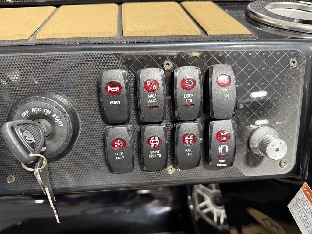 Control panel of 2025 Premier 230 Solaris RL with labeled switches and ignition key.