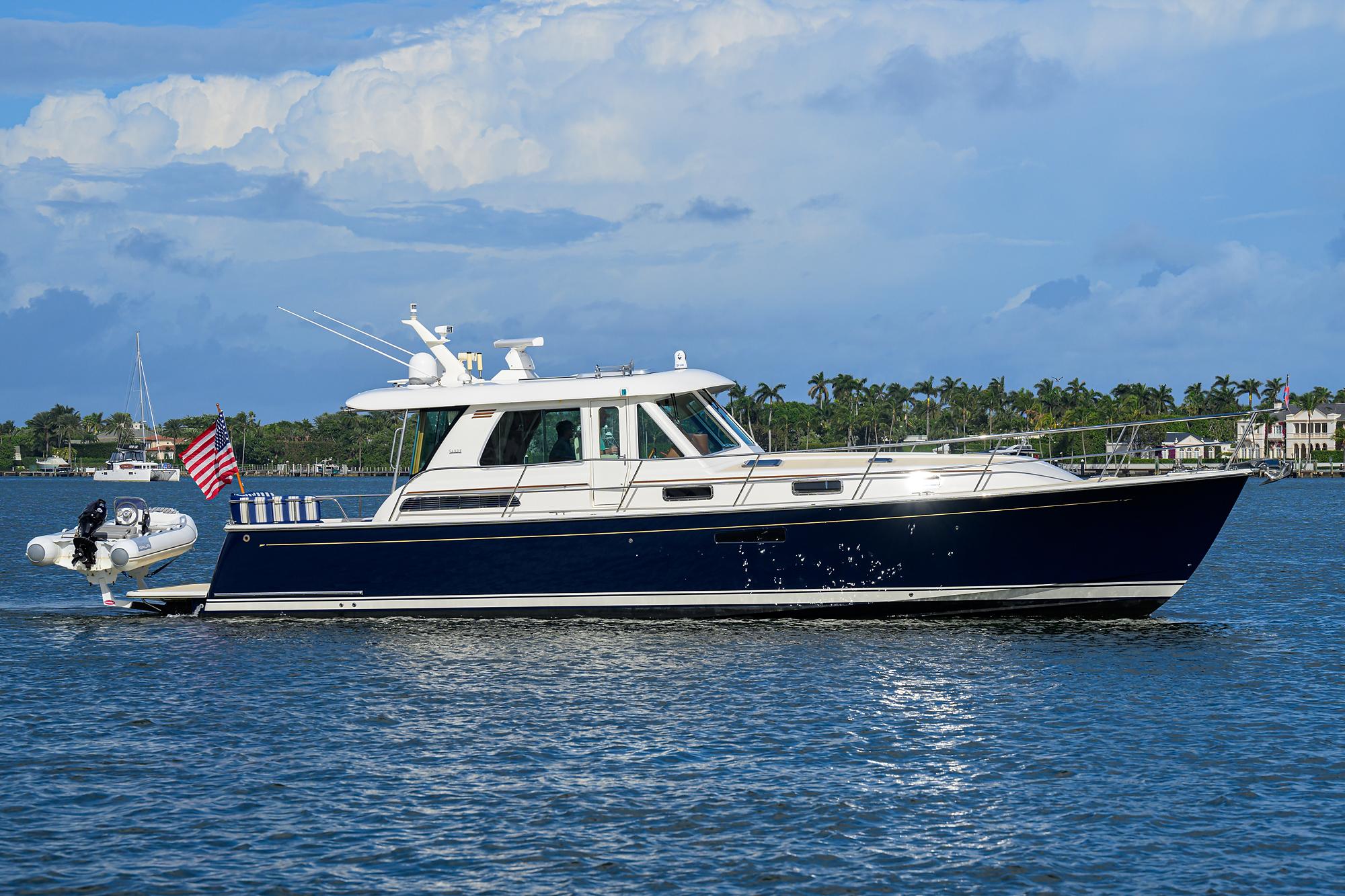 2018 Sabre 48 Salon Express yacht cruising on a sunny day with a scenic backdrop.