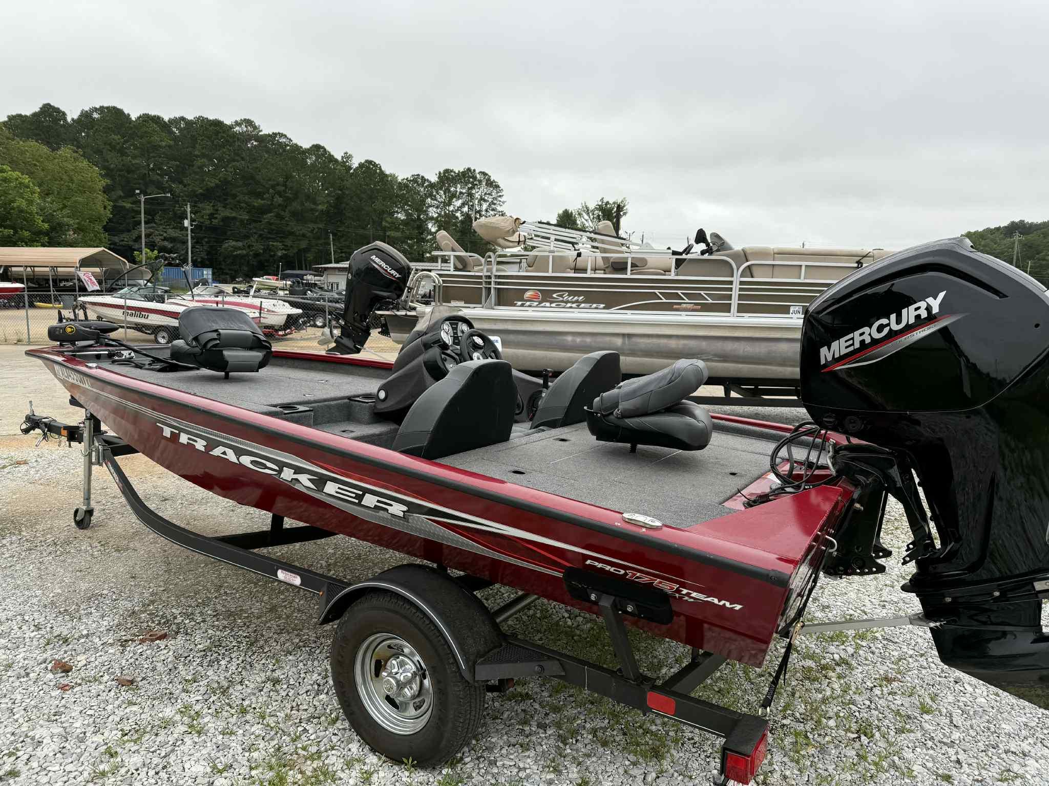 2022 Tracker Pro Team 175 TXW boat with Mercury engine on trailer, parked outdoors.