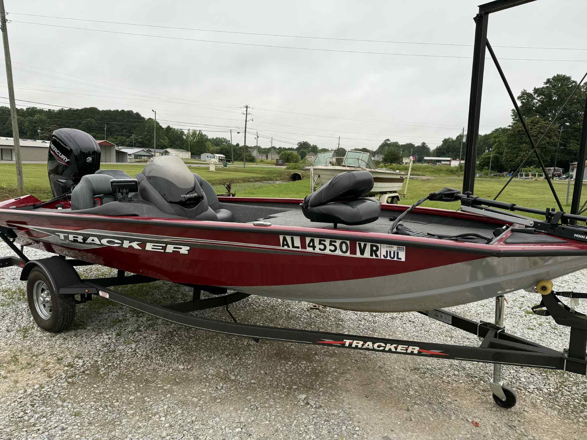 2022 Tracker Pro Team 175 TXW boat on trailer, parked on gravel.