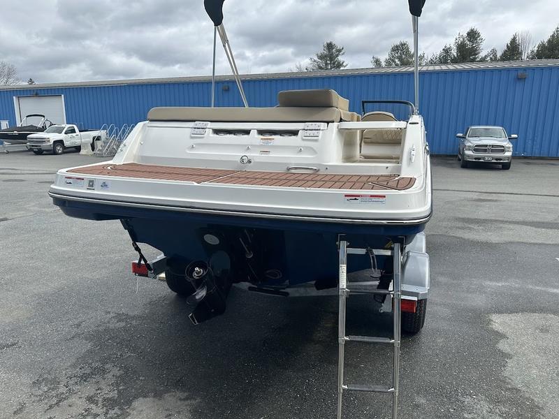 2023 Bayliner VR6 boat, rear view, parked on trailer in outdoor lot.