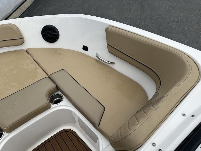 2023 Bayliner VR6 boat interior with beige seating and cup holder.