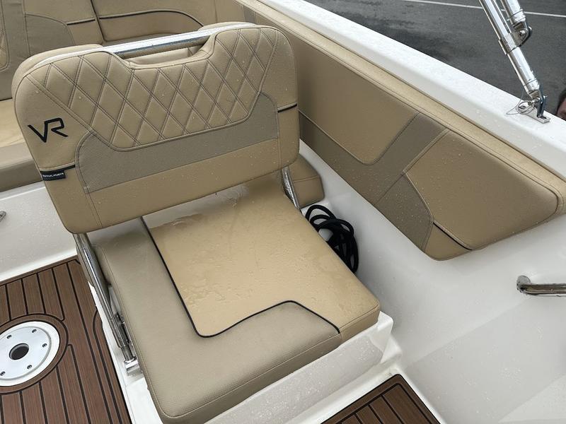 2023 Bayliner VR6 boat interior with beige seating and wood accents.