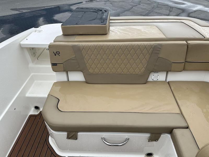 2023 Bayliner VR6 boat interior with beige cushioned seating and diamond pattern design.