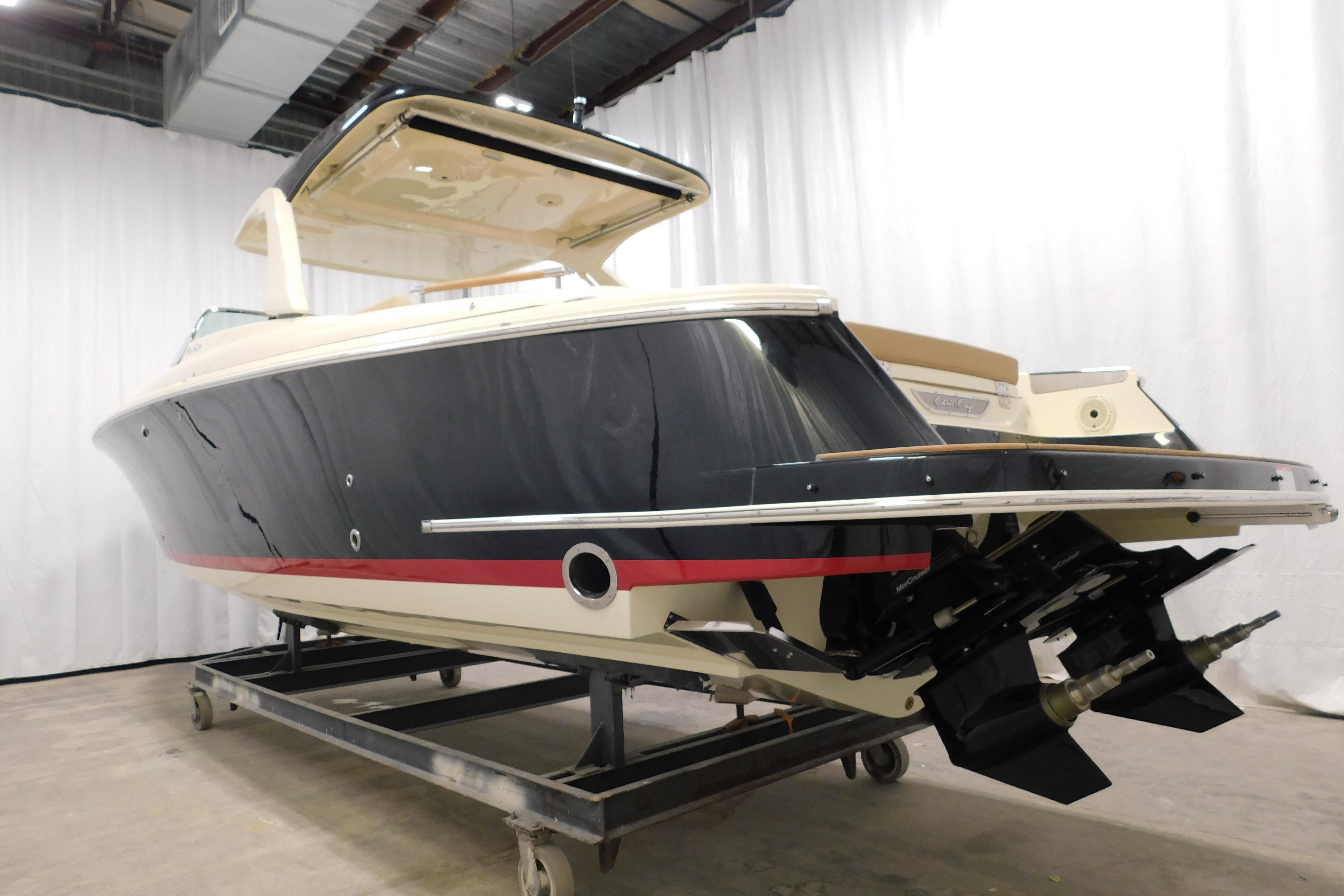 2021 Chris-Craft Launch 35 GT boat in showroom, side view, elegant design.