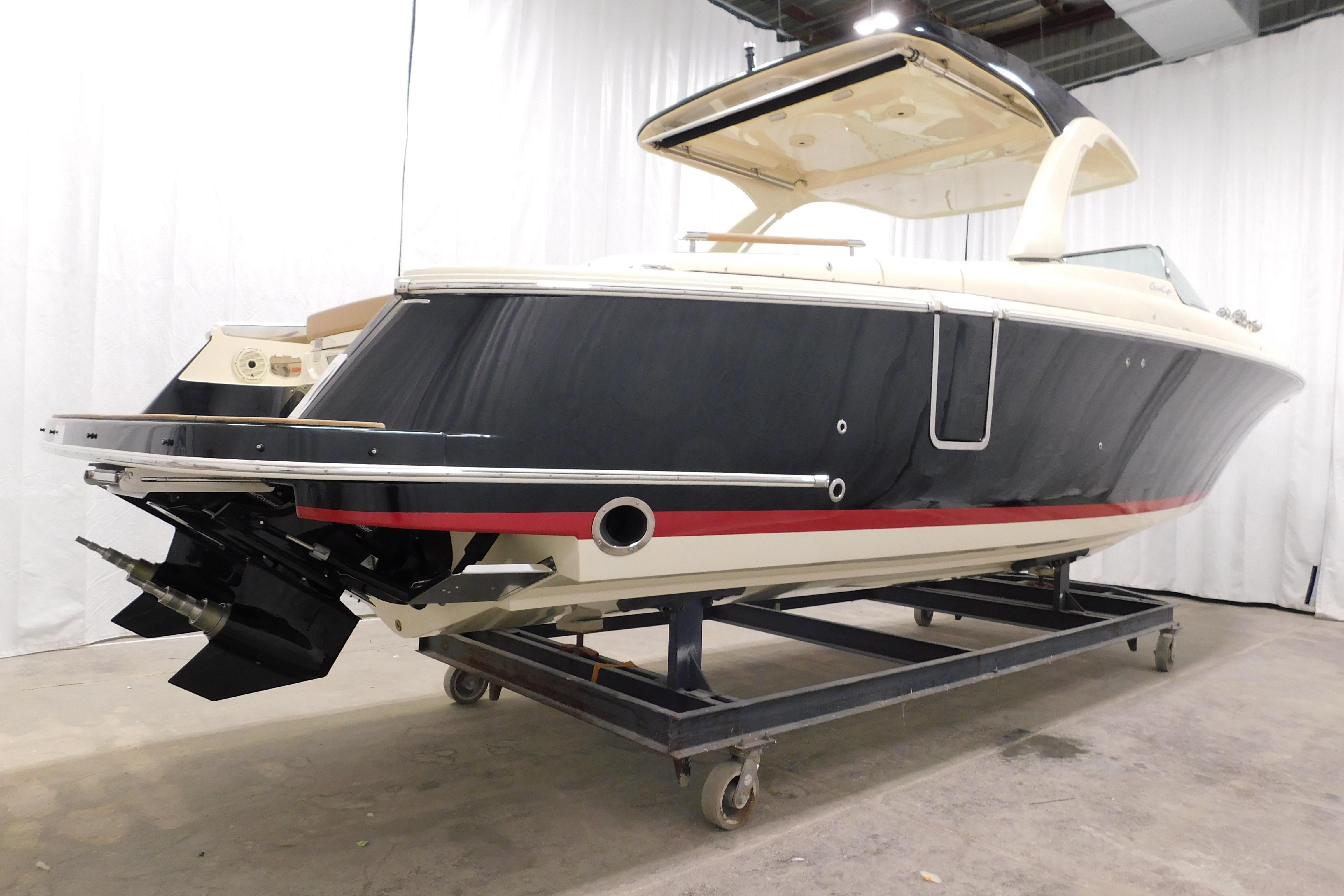 2021 Chris-Craft Launch 35 GT boat in showroom, side view with sleek design.