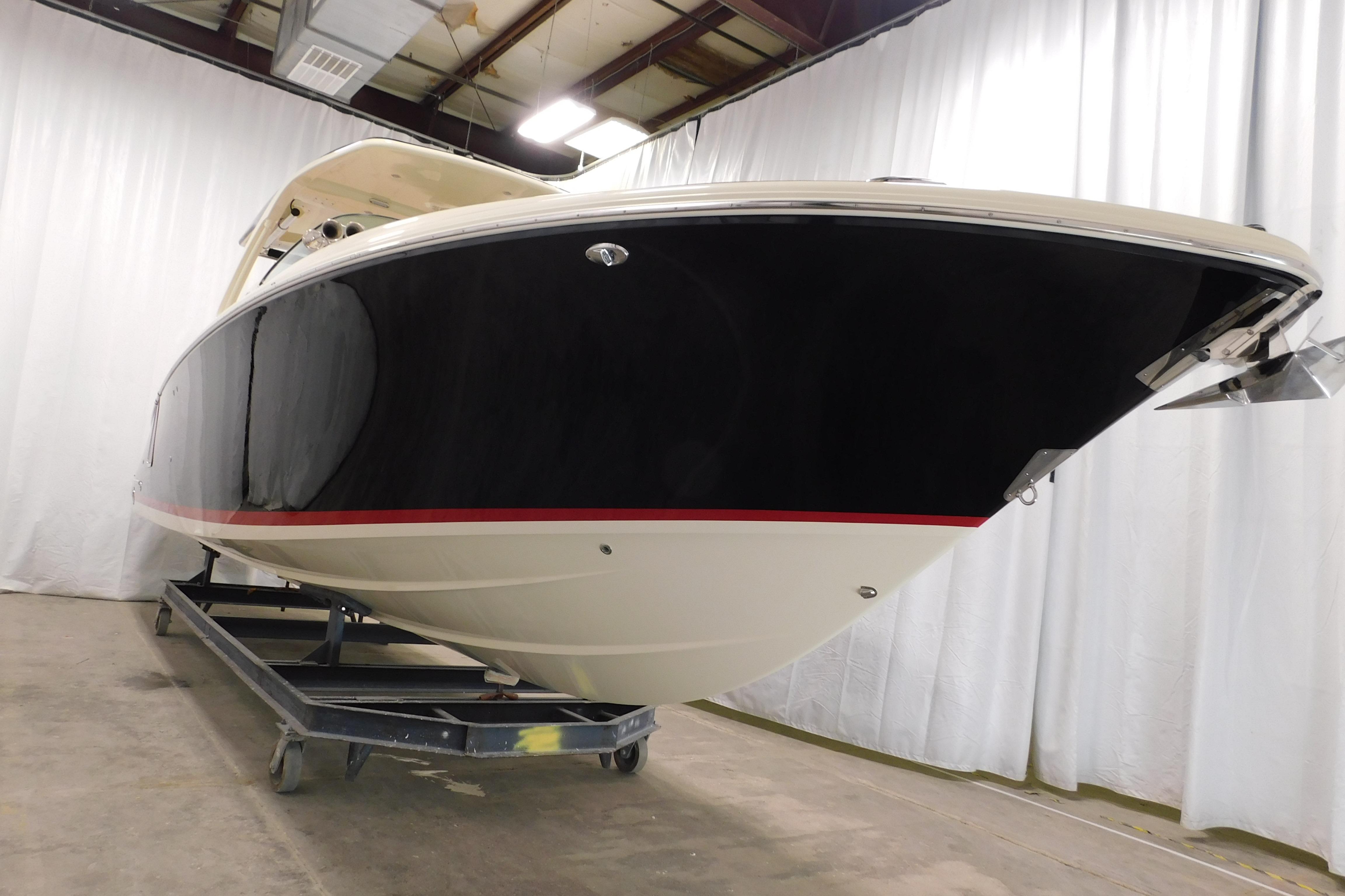 2021 Chris-Craft Launch 35 GT boat in indoor storage, showcasing sleek design and craftsmanship.