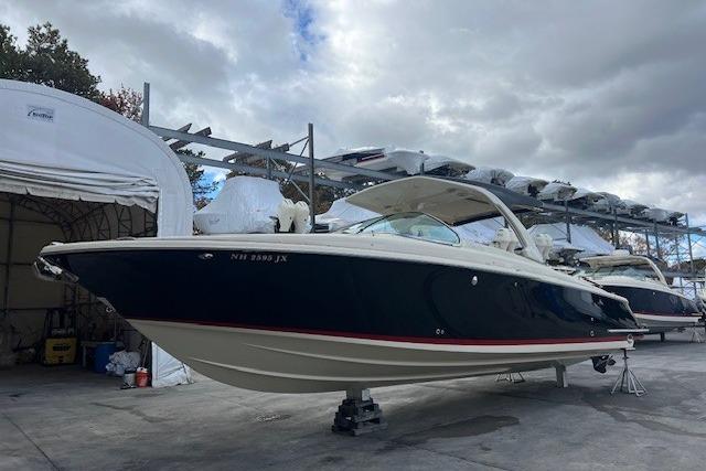 2021 Chris-Craft Launch 35 GT boat in storage, under cloudy skies.