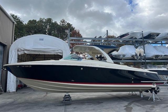 2021 Chris-Craft Launch 35 GT boat in storage, showcasing sleek design and elegant navy hull.