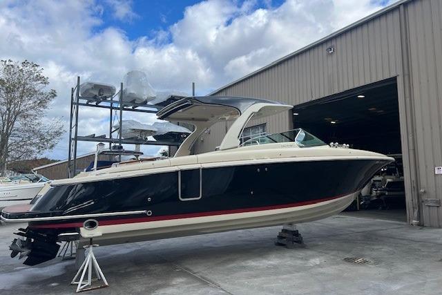 2021 Chris-Craft Launch 35 GT boat in a marina, parked near a storage facility.