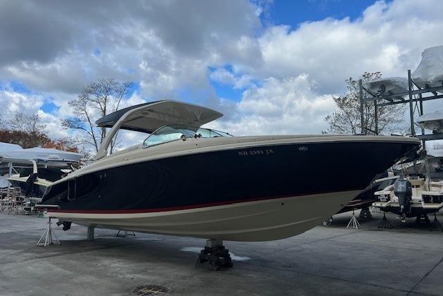 2021 Chris-Craft Launch 35 GT boat on display under cloudy sky.