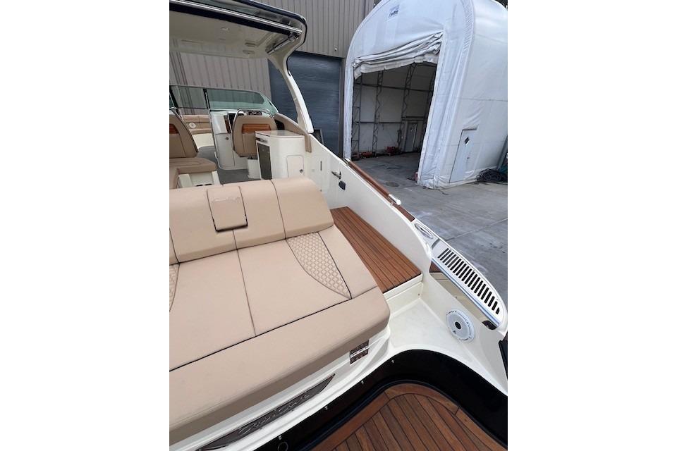 2021 Chris-Craft Launch 35 GT boat interior with beige seating and wooden deck.