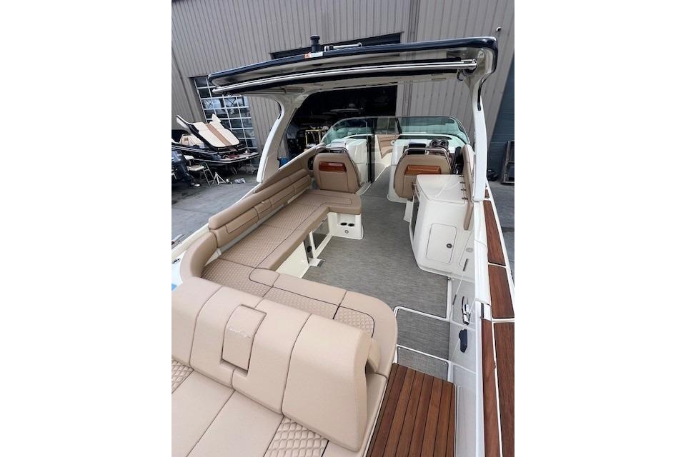2021 Chris-Craft Launch 35 GT boat interior with beige seating and wood accents.