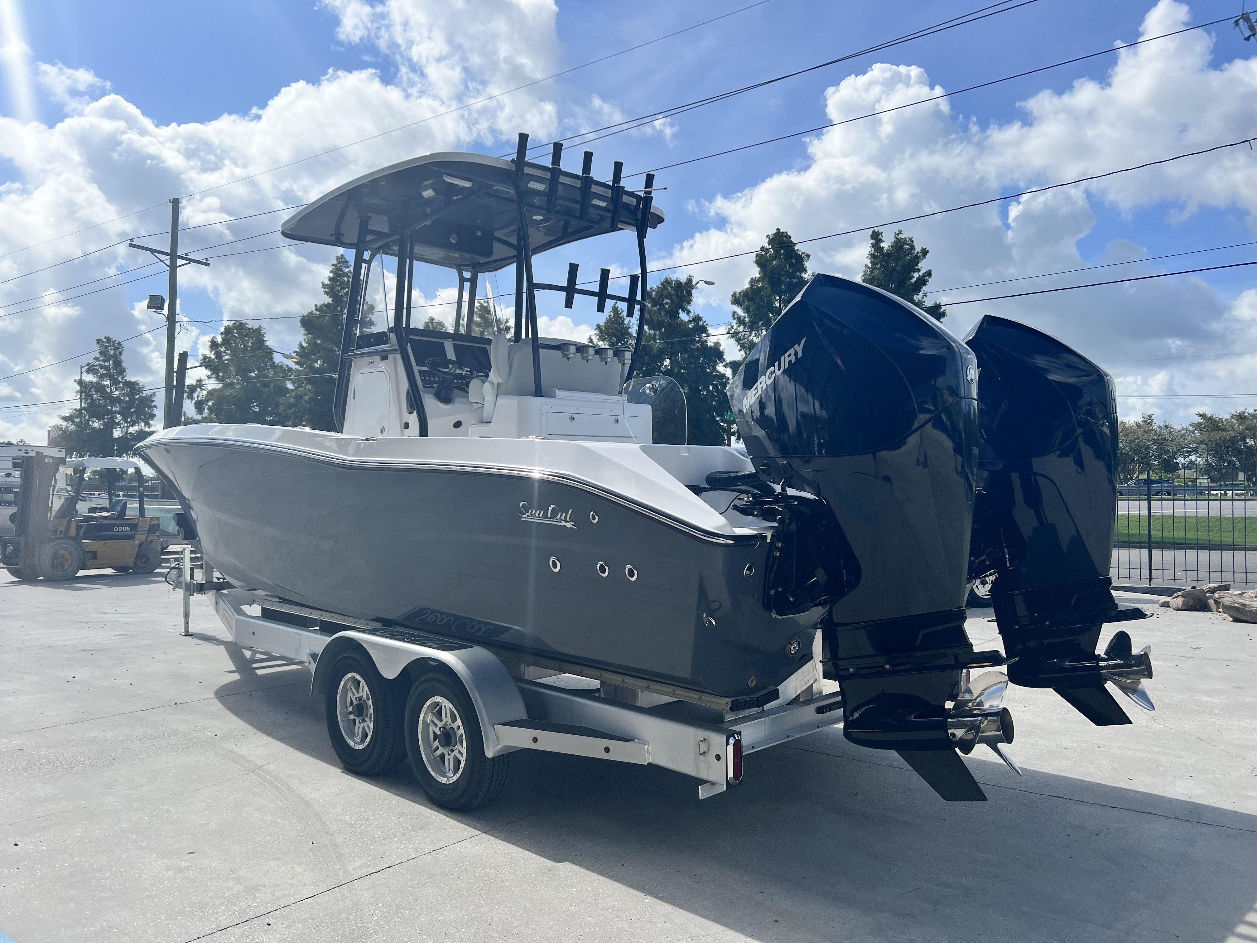 2023 Sea Cat 260 HC boat with dual Mercury engines on trailer, under sunny sky.