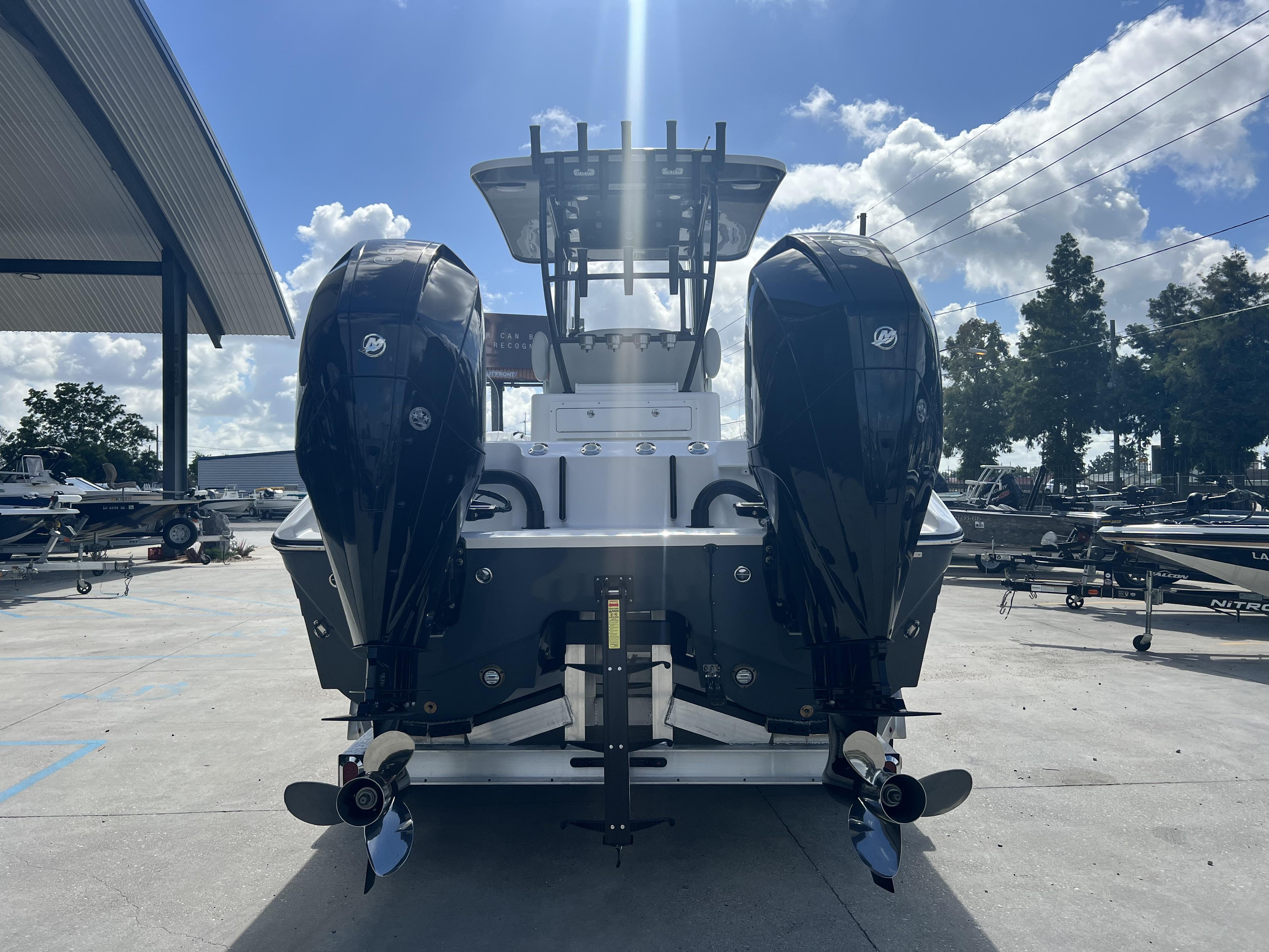 2023 Sea Cat 260 HC boat with dual outboard motors in a marina setting.