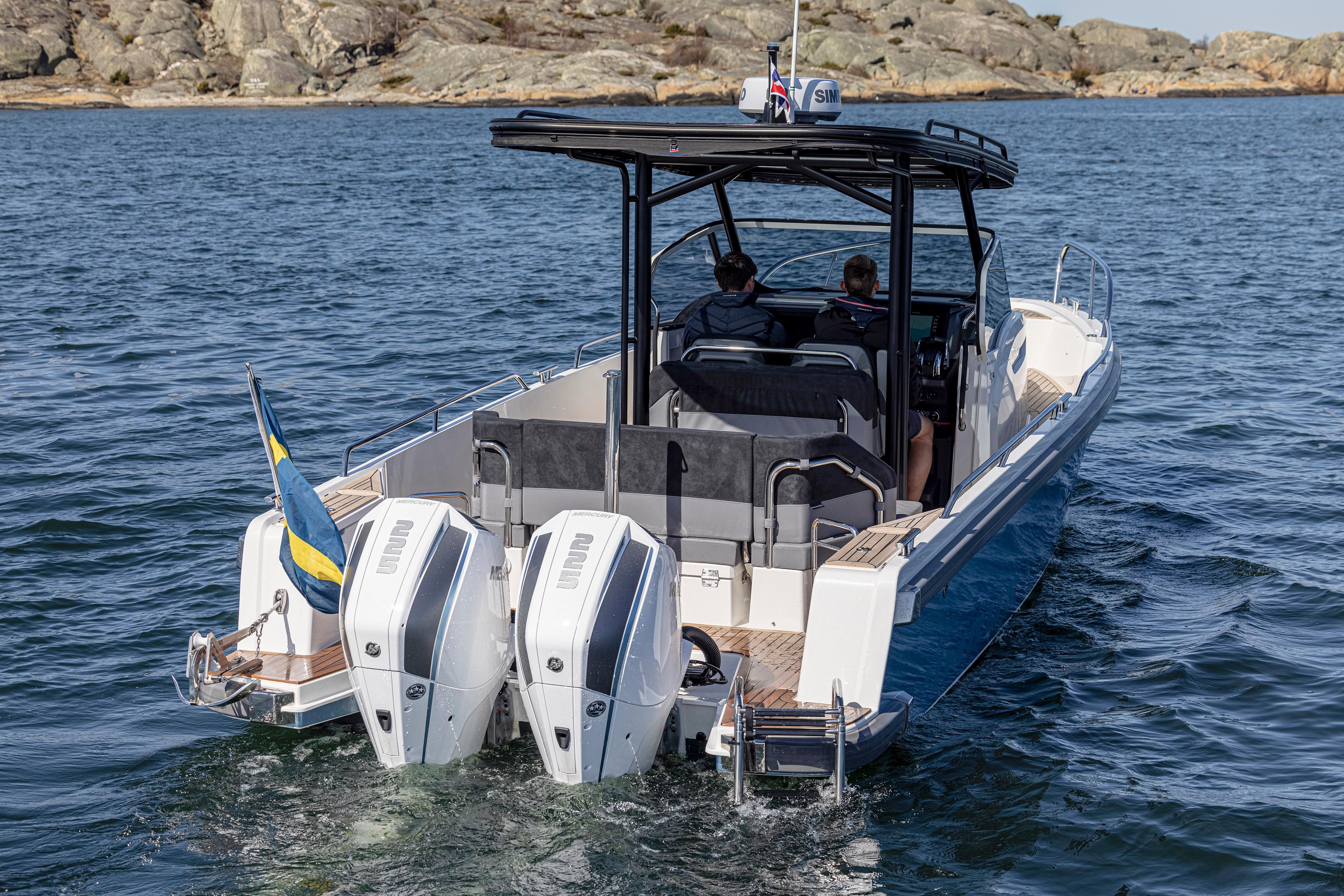 Nimbus-T9 2023-ANN #121 MD-US-Nimbus T9 #121 Twin Engine 2023 boat cruising on water with rocky shoreline in background.-9024384